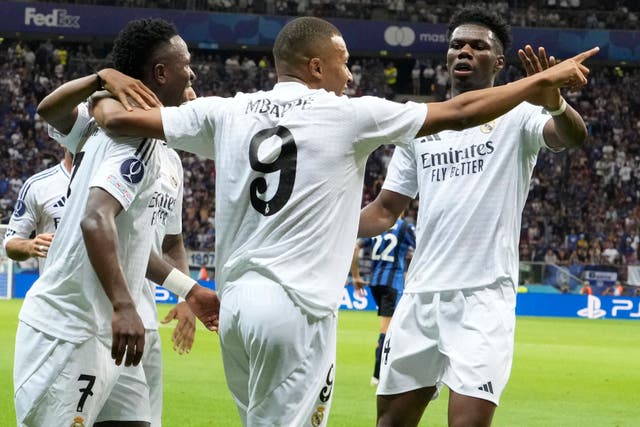 Kylian Mbappe, centre, celebrates after scoring on his debut for Real Madrid in the UEFA Super Cup (Czarek Sokolowski/AP)