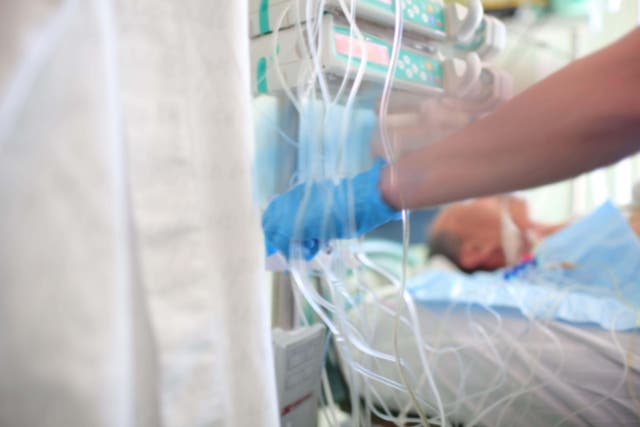 A nurse operates equipment in an intensive care ward (Alamy/PA)