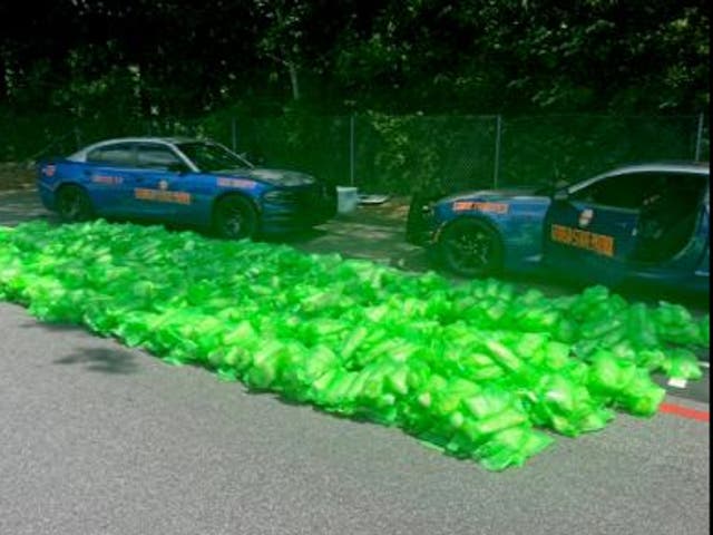 <p>Two police cars sit parked by a load of seized methamphetamine found at the Atlanta State Farmers Market on August 8, 2024</p>