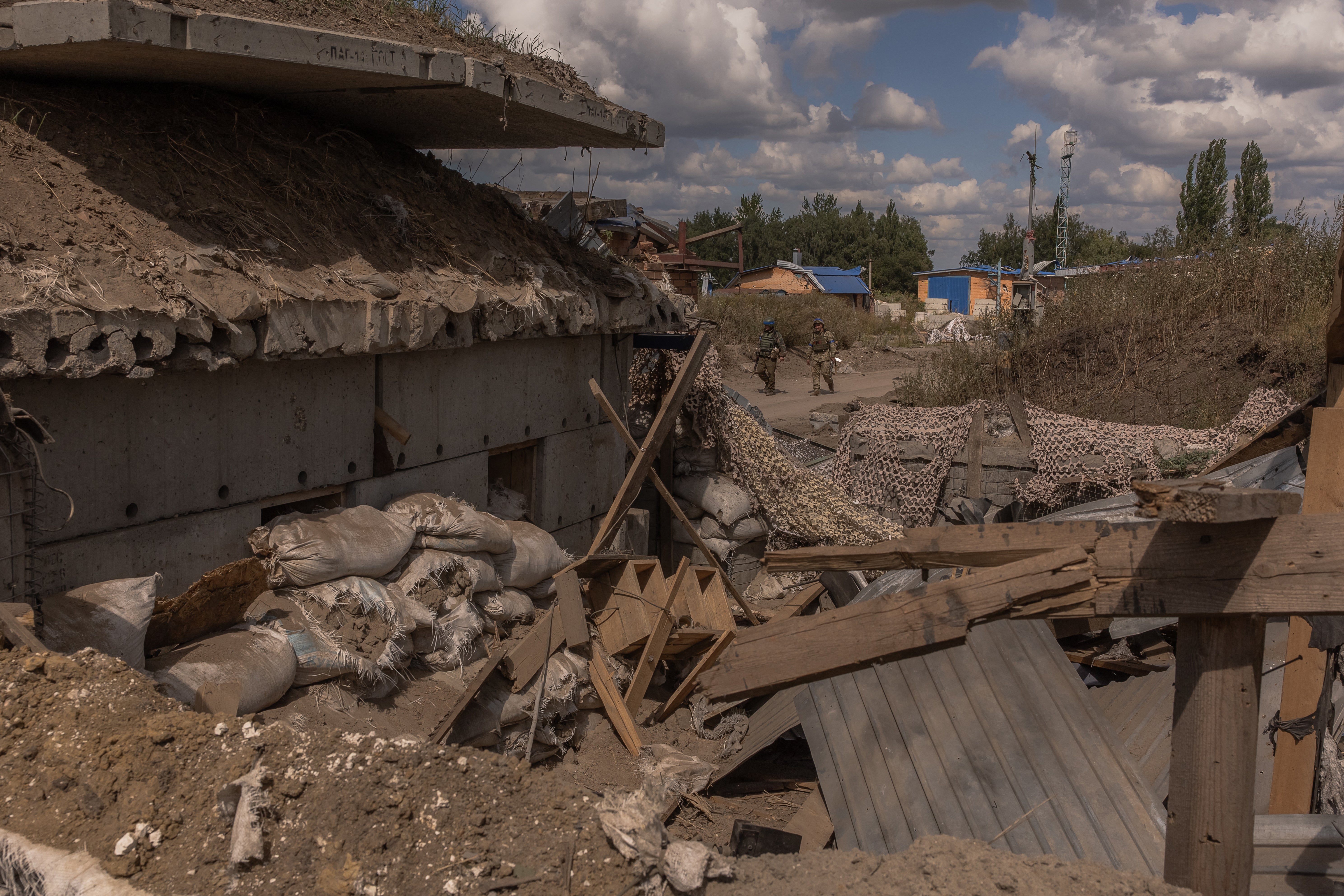 Ukrainian servicemen guard an area at a destroyed border crossing point with Russia