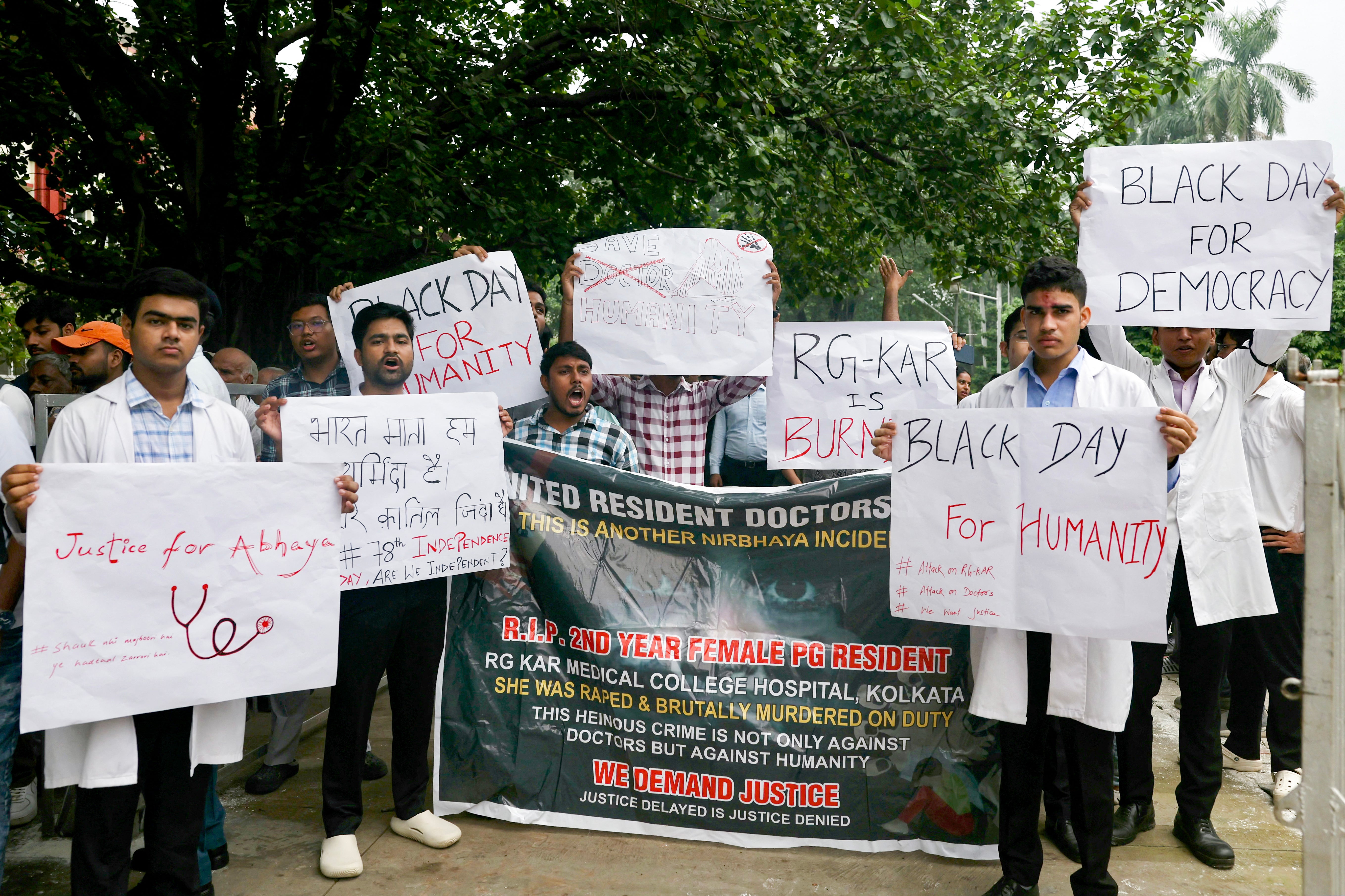 Medical students hold up placards to protest against the rape and murder of a young doctor from Calcutta.