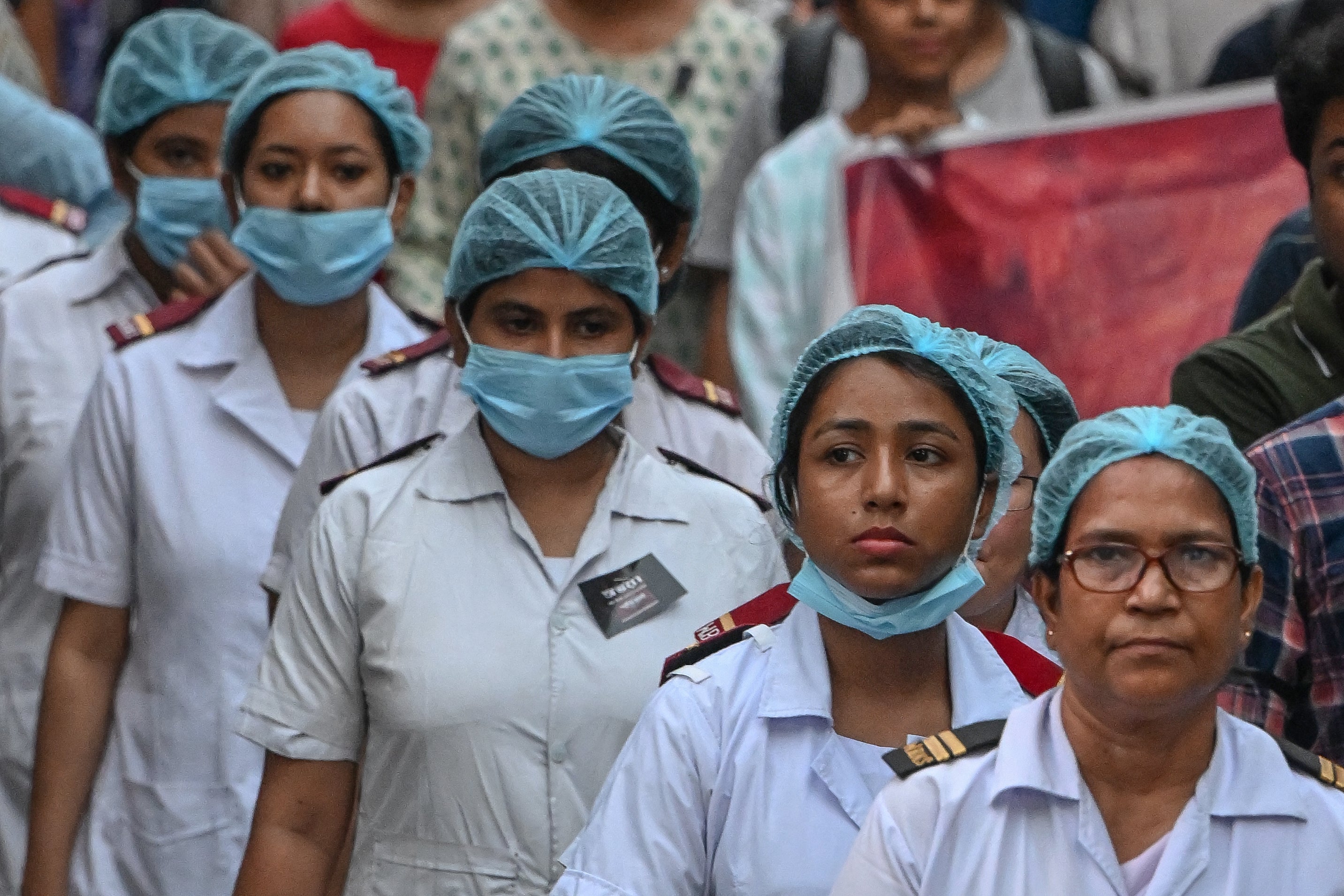 Medical professionals take part in a silent march in Calcutta to condemn the rape and murder of a doctor.