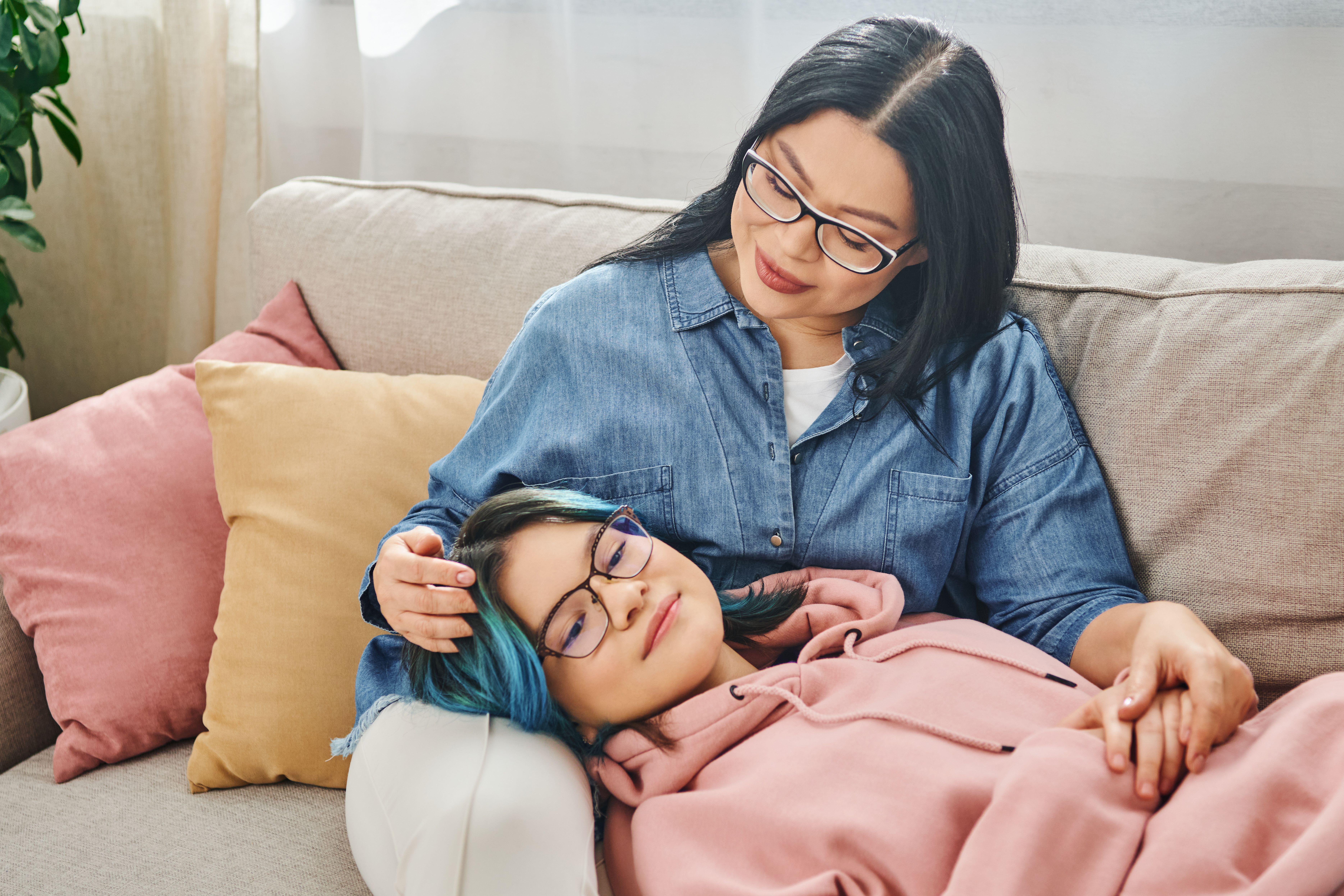 If you stay calm your child will feel more relaxed (Alamy/PA) side by side on a couch in casual clothes.