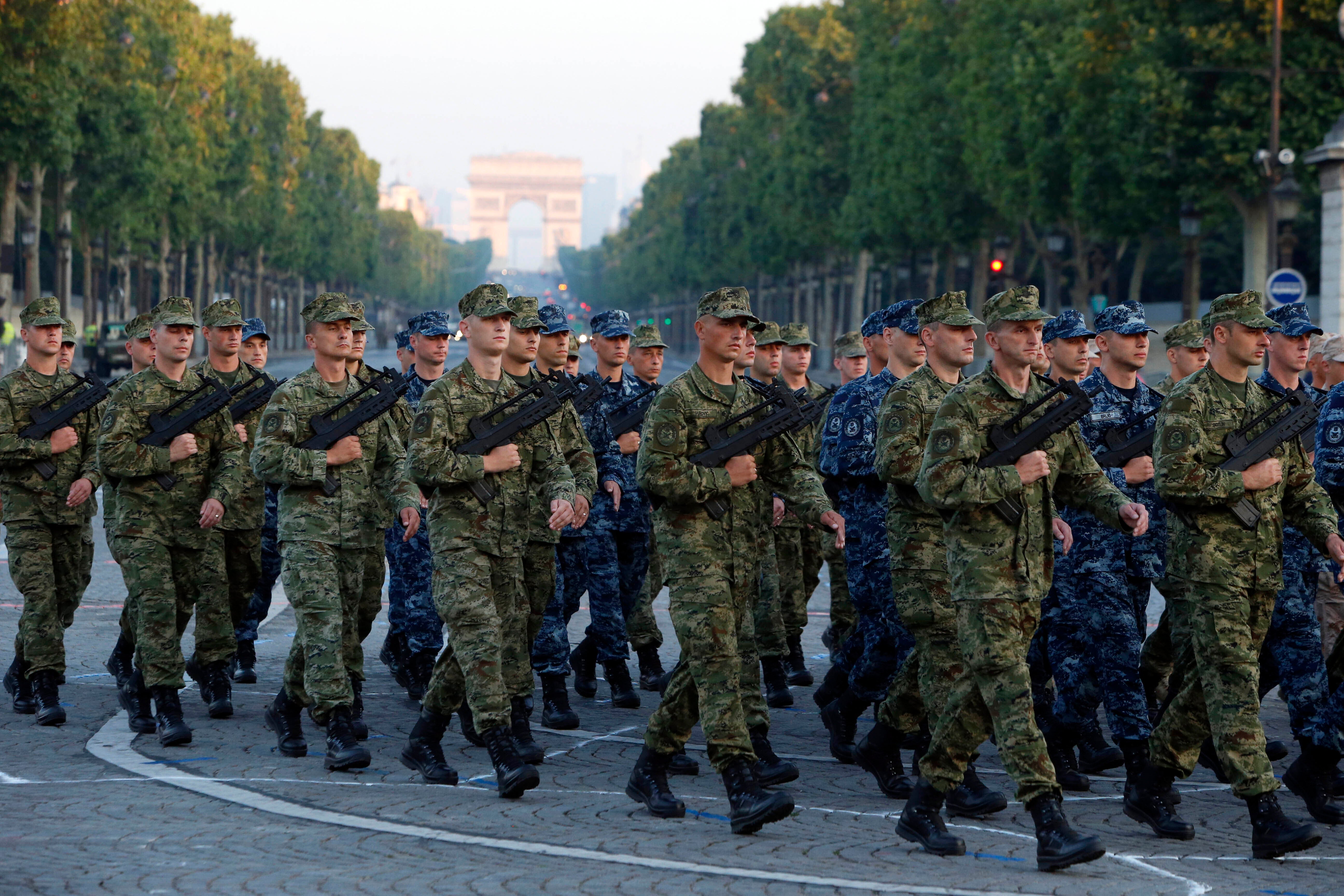 FILE - Army Forces of Croatia walk during the rehearsal of the French Bastille Day parade at the Champs-Elysees avenue in Paris, Tuesday, July 9, 2013