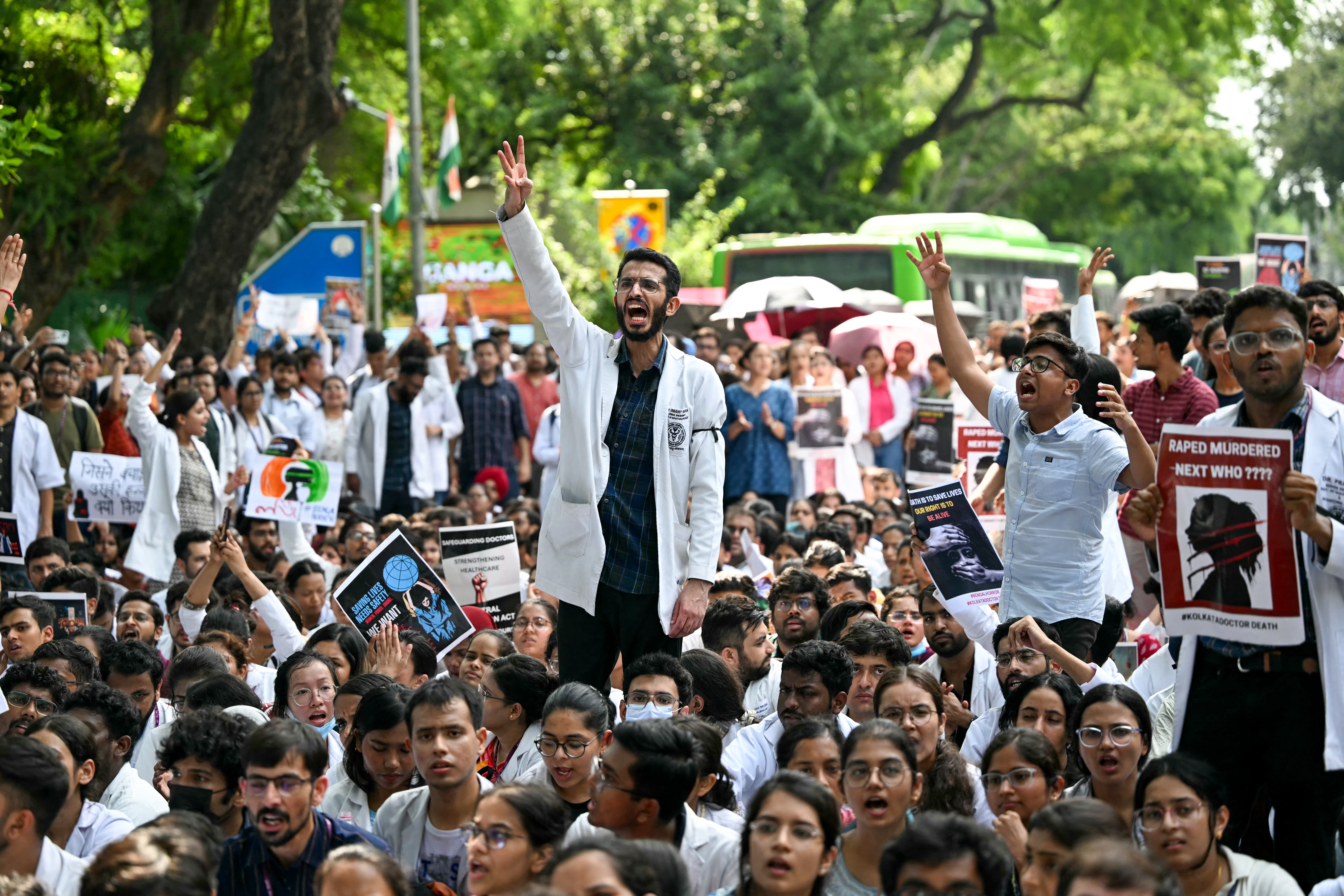 Medical professionals and students shout slogans as they condemn the rape and murder of a doctor in India’s West Bengal state