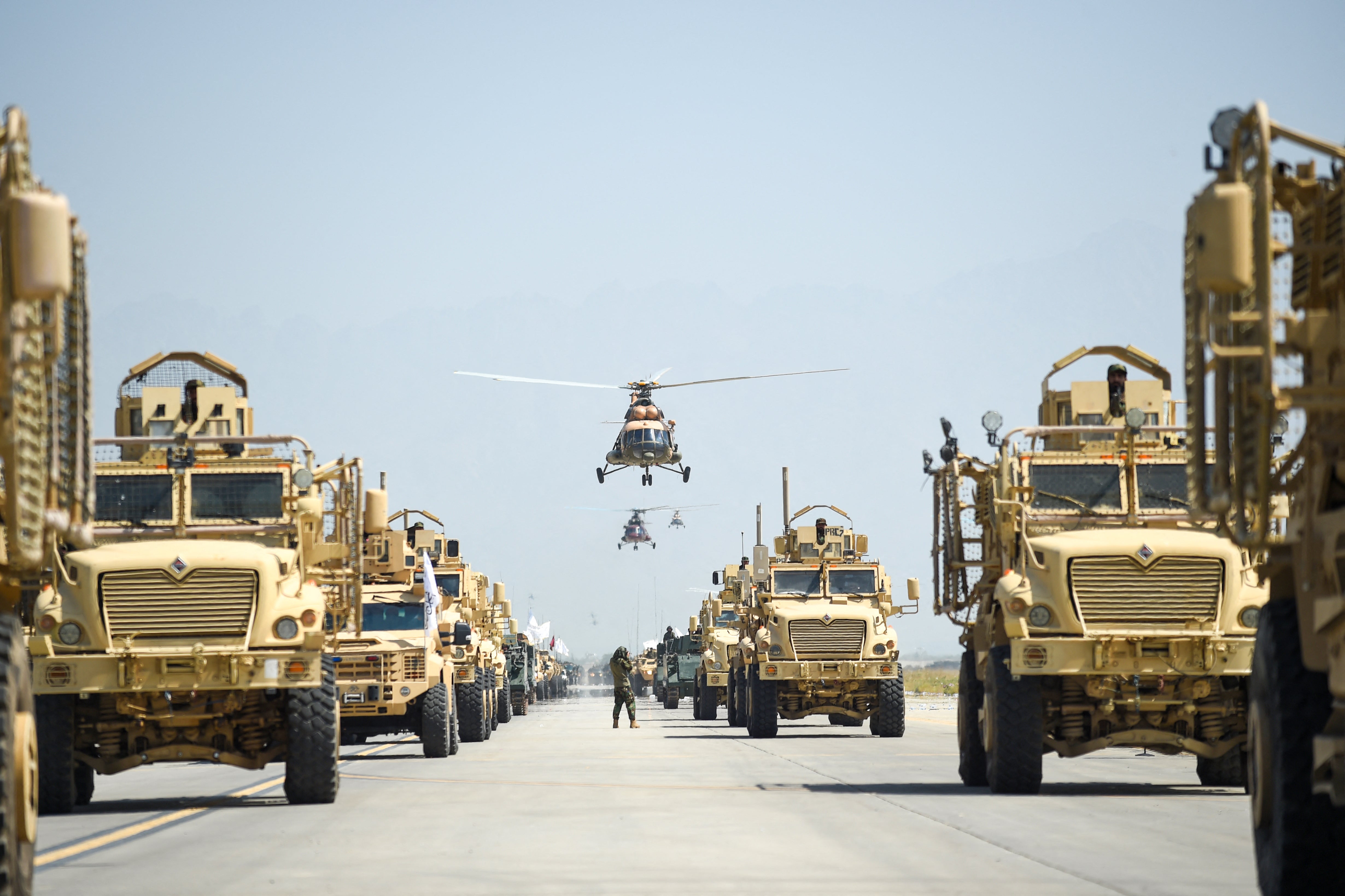 Taliban military vehicles parade to celebrate the third anniversary of the Taliban takeover of Afghanistan