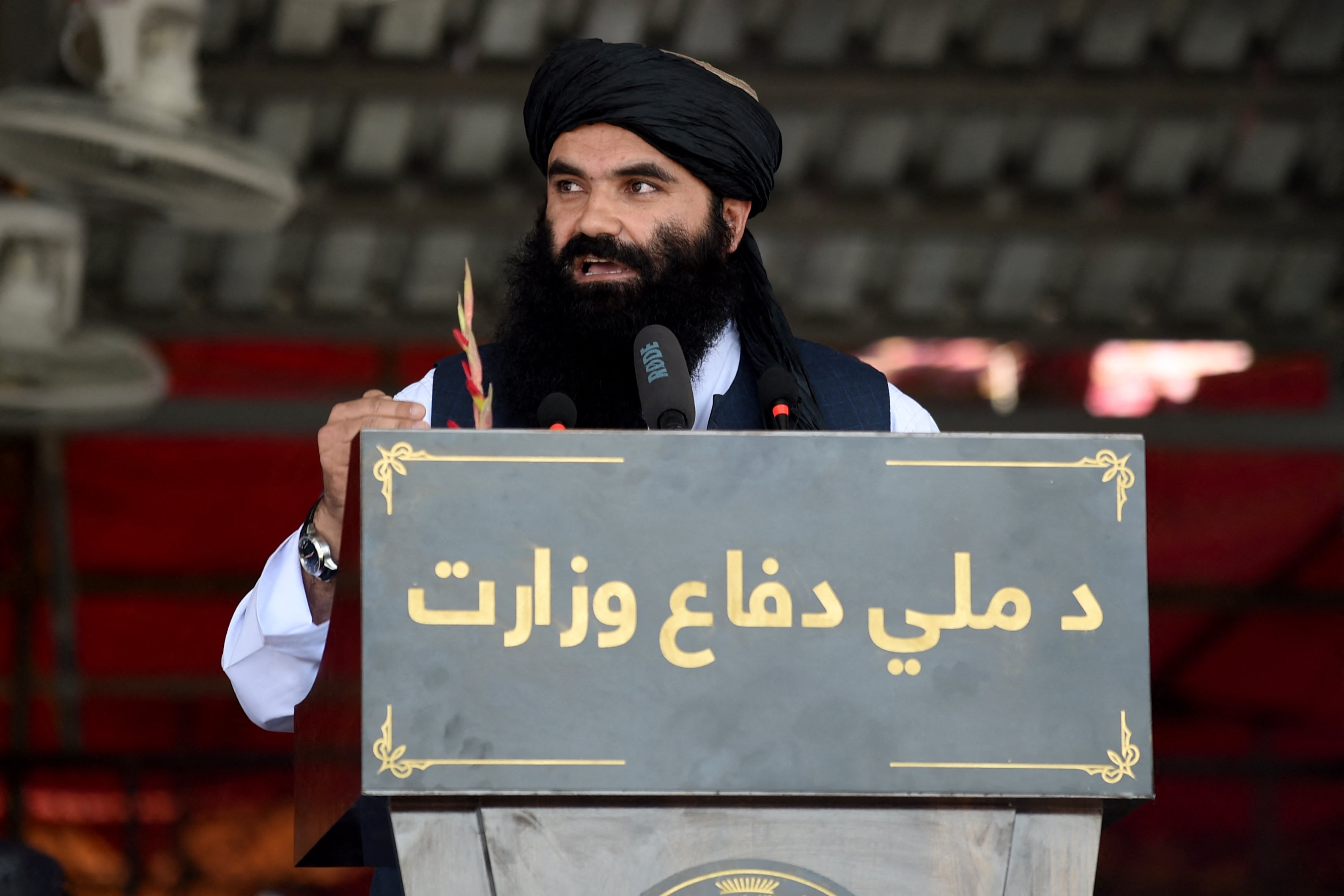 Taliban interior minister Sirajuddin Haqqani speaks during a military parade at Bagram