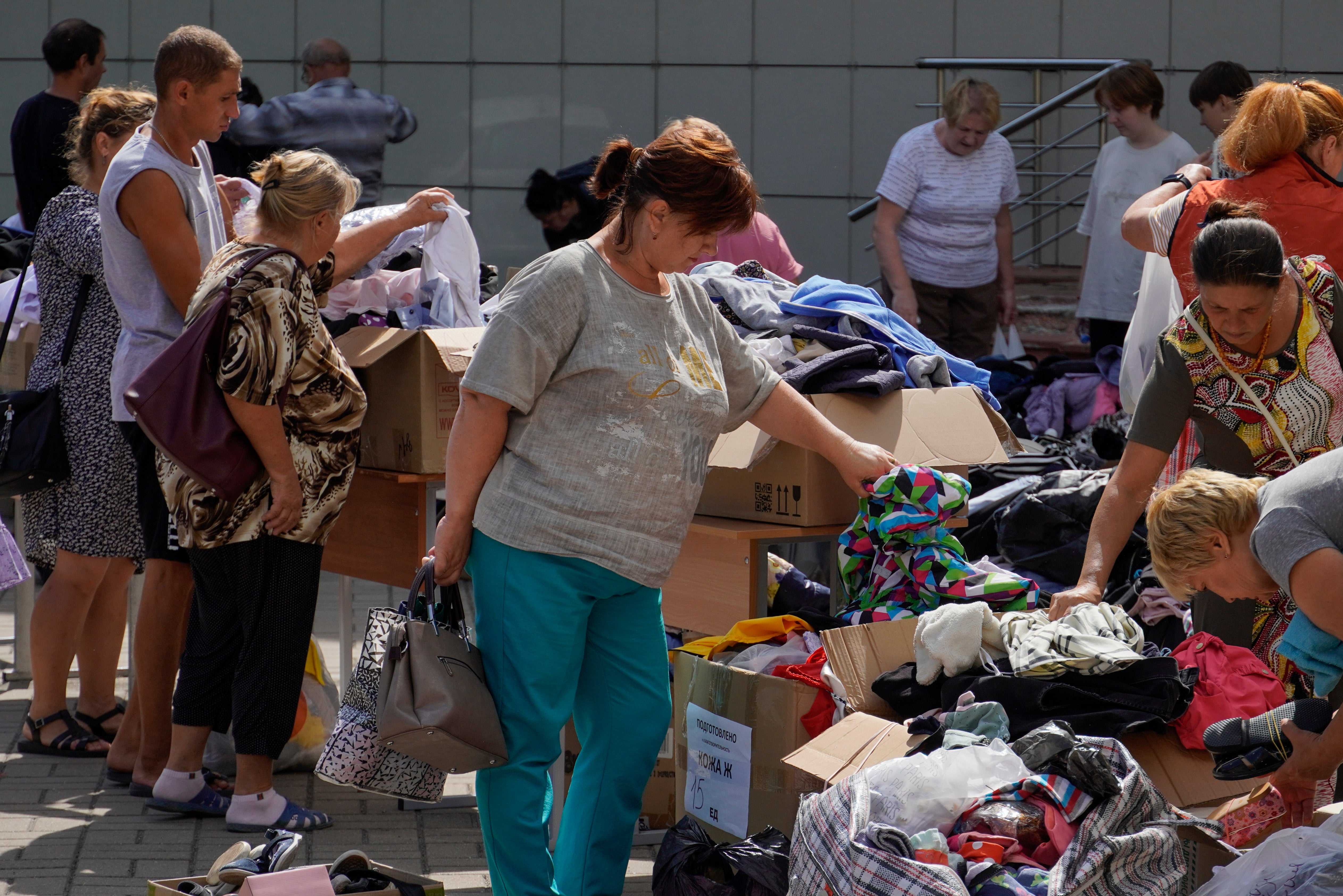 Civilians evacuated from the border of the Kursk region receive humanitarian aid as they arrive in the center of Kursk, Russia