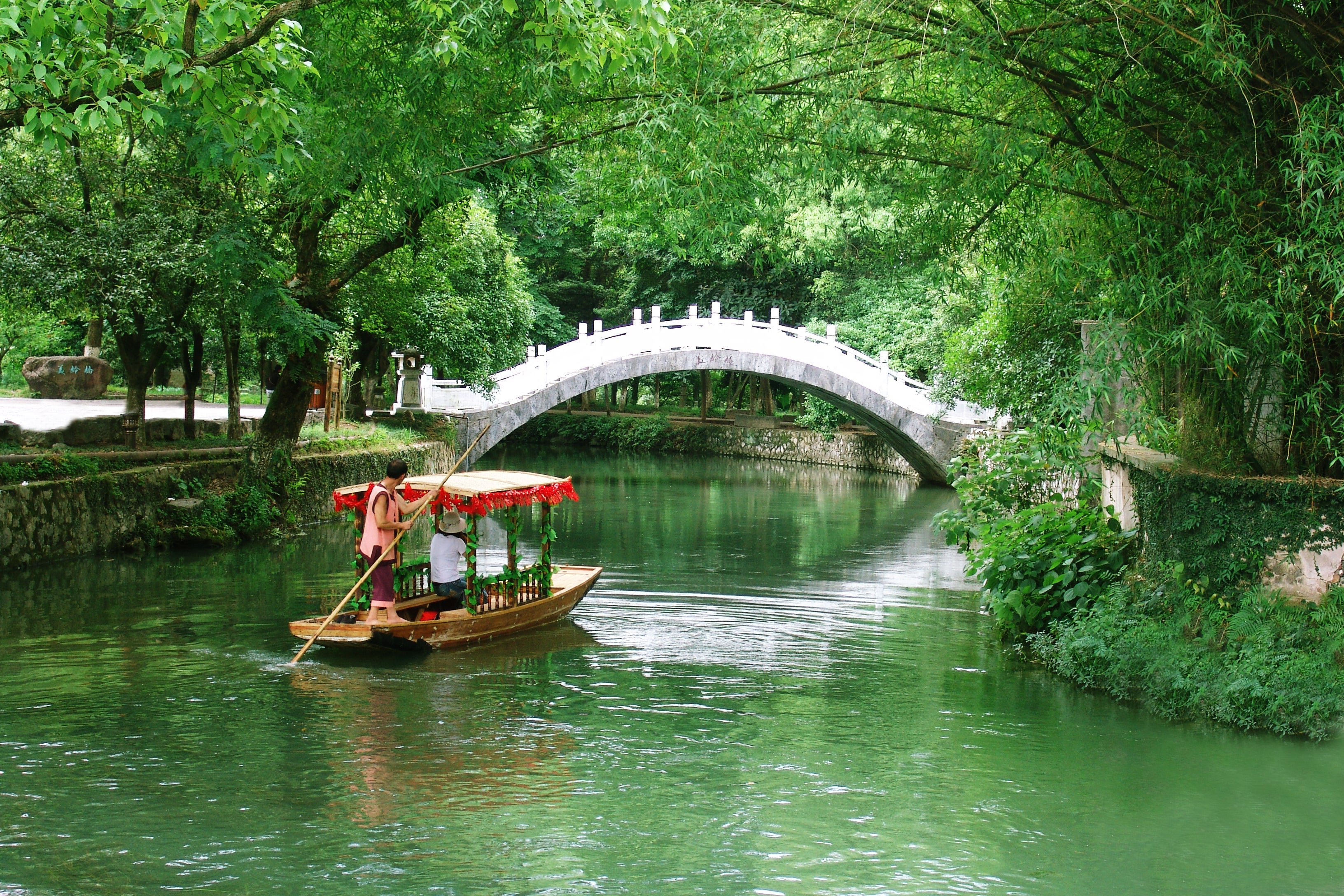 A boat ride allows visitors to take in the lush greenery lining the Lingqu Canal, in Guilin, Guangxi Zhuang autonomous region