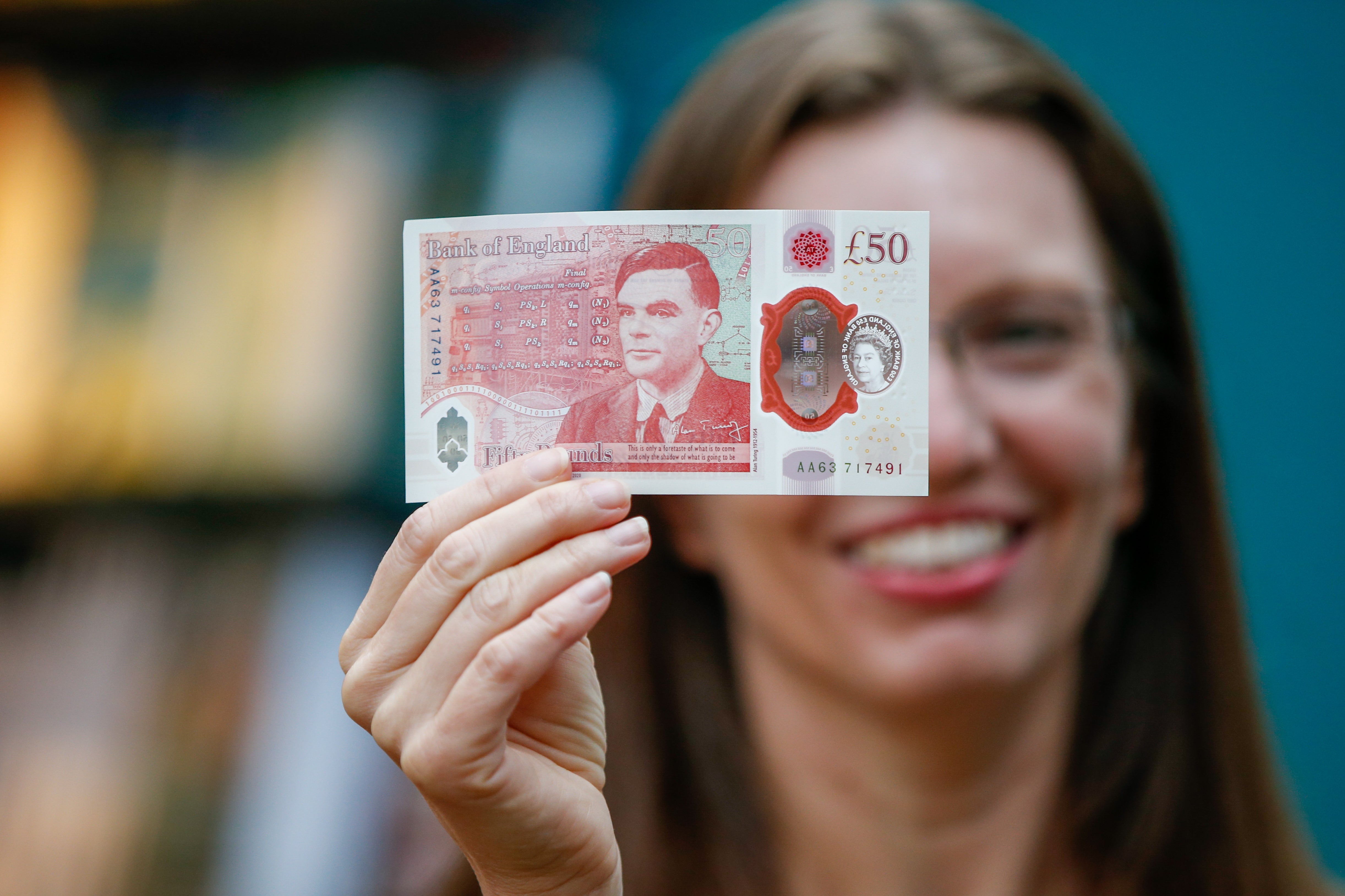 Sarah John, chief cashier of the Bank of England, with an Alan Turing £50 banknote at Daunt Books in London (Hollie Adams/PA)