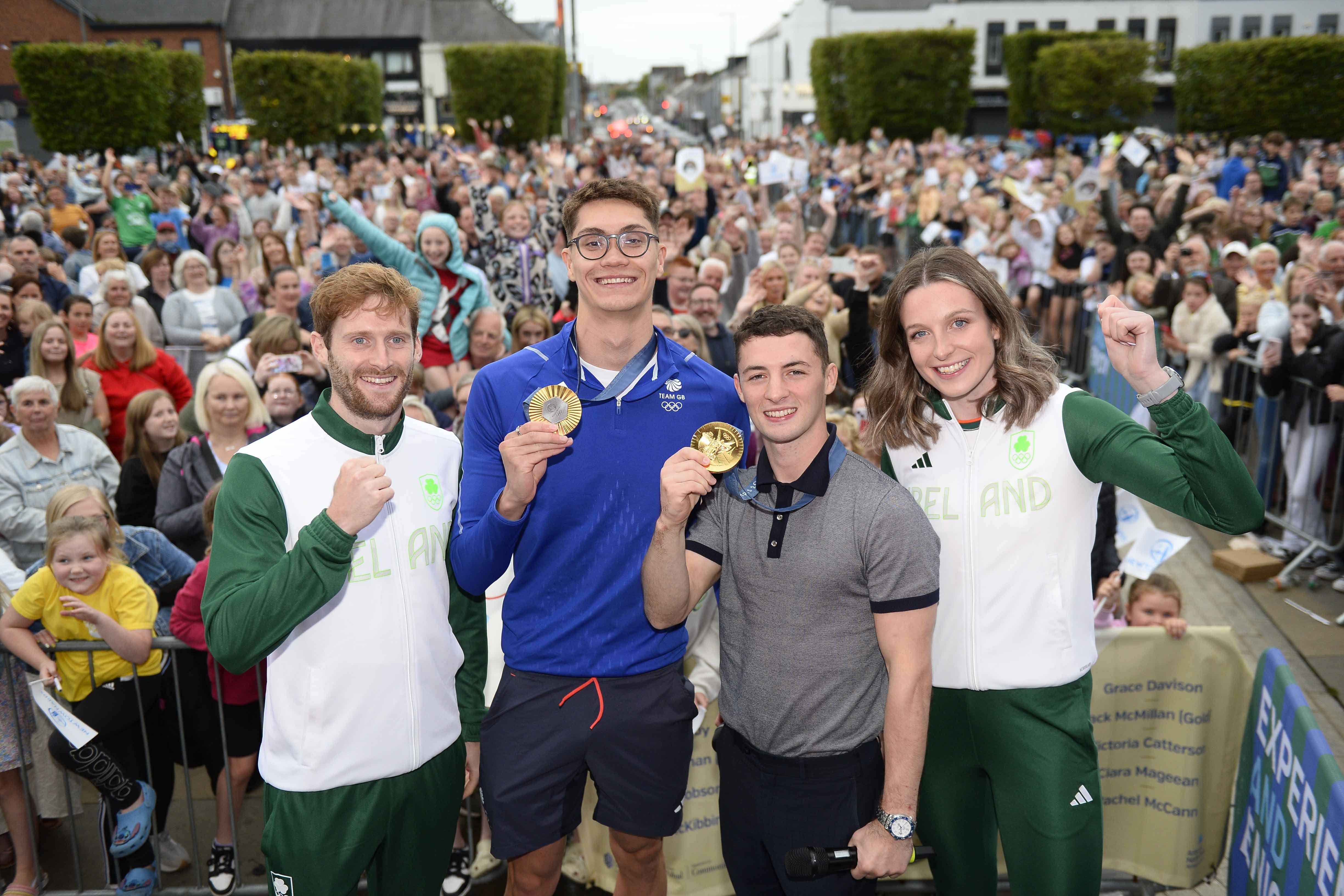 (left-right) Irish international hockey player Michael Robson, Olympic gold medallists Jack McMillan, who won gold for TeamGB in swimming, and Rhys McClenaghan, who won gold for Ireland in gymnastics and runner Rachel McCann during a homecoming celebration in Newtownards, County Down, Northern Ireland. (Mark Marlow/PA)