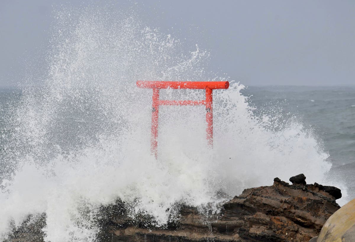 Typhoon Ampil moves away from Japan as train services resume and no major damage is reported