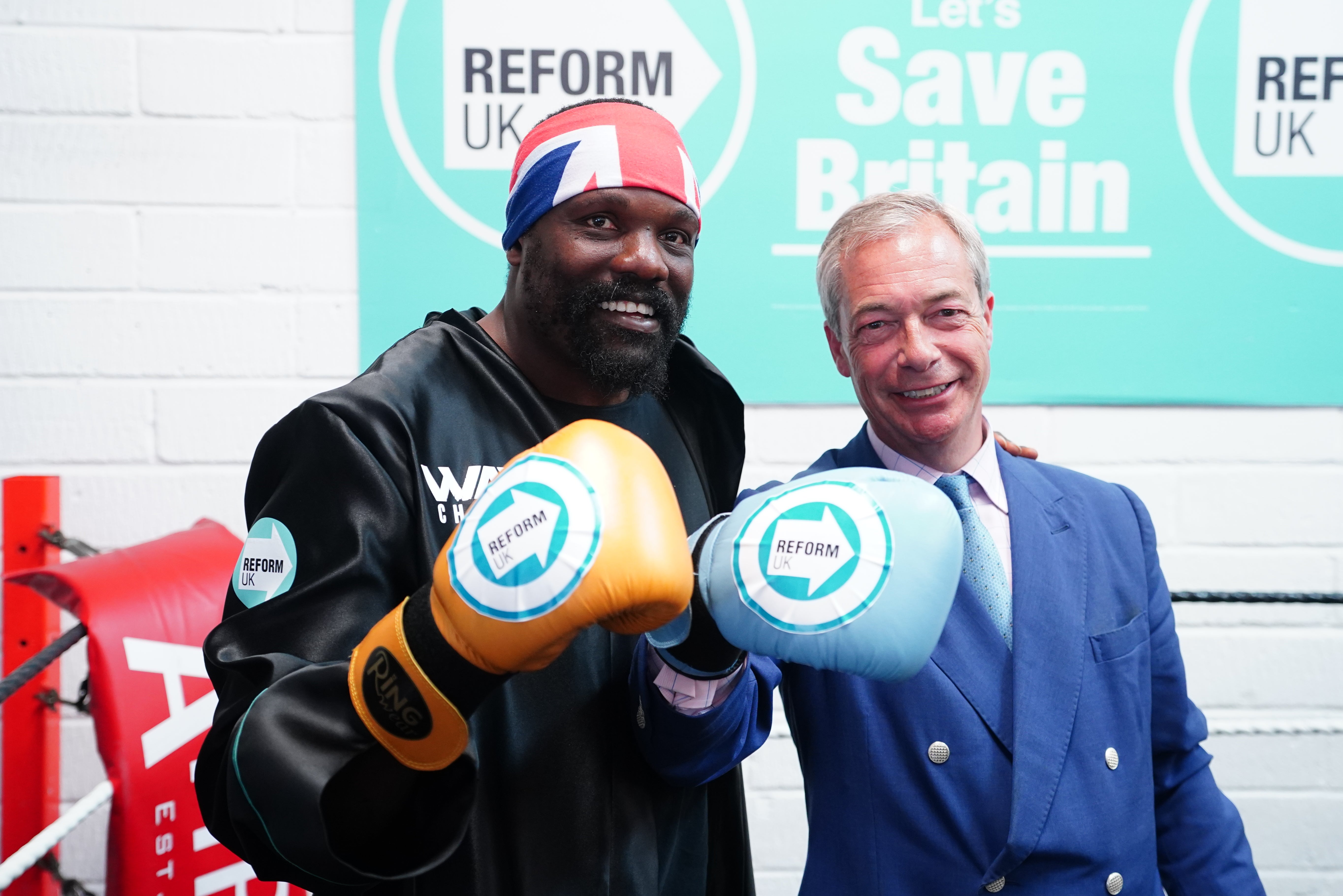 Reform UK leader Nigel Farage, with boxer Derek Chisora, wearing boxing gloves at a gym in Clacton while on the general election campaign trail