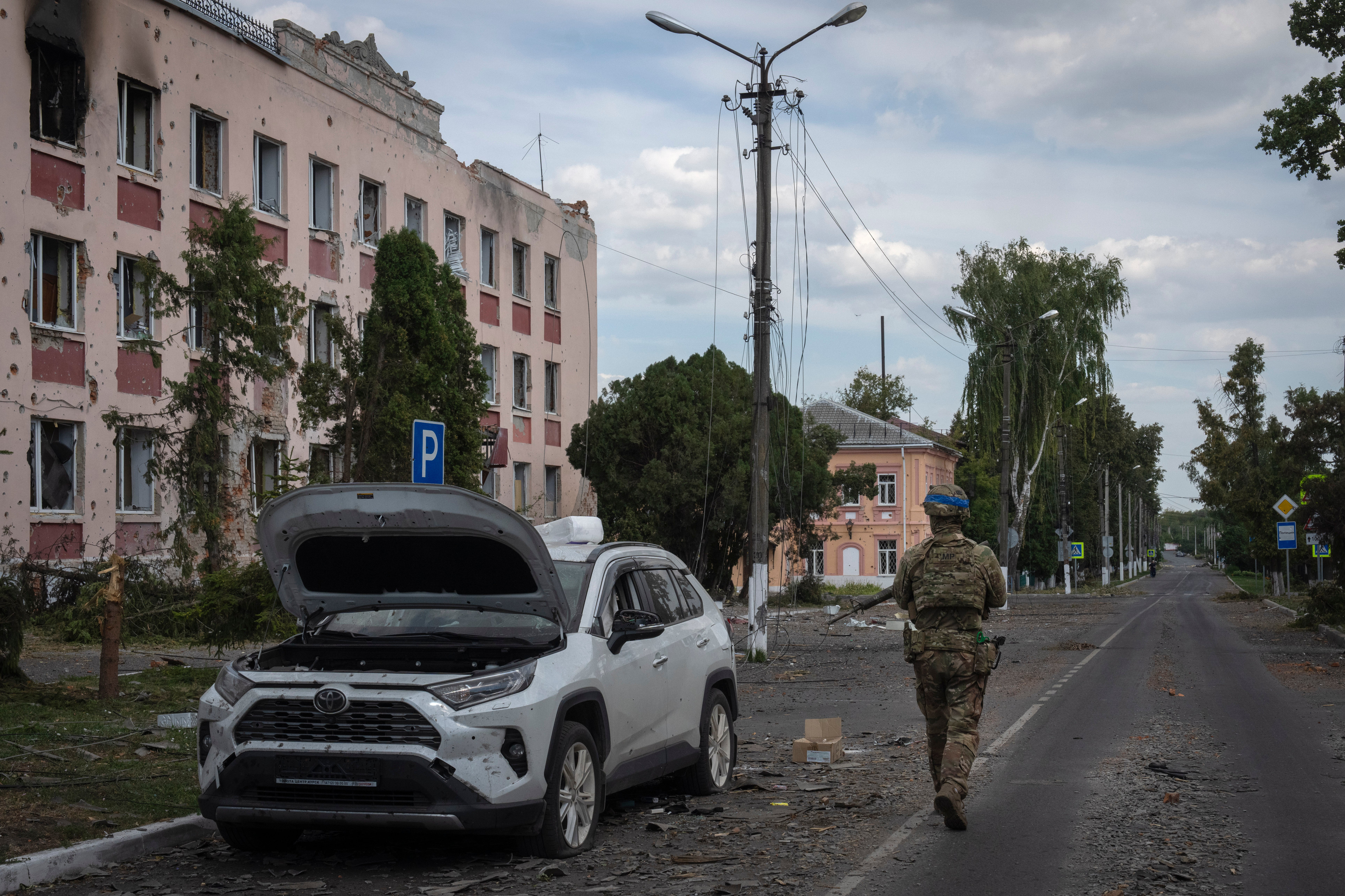 A Ukrainian soldier walks past at a city hall in Sudzha, Kursk region, Russia