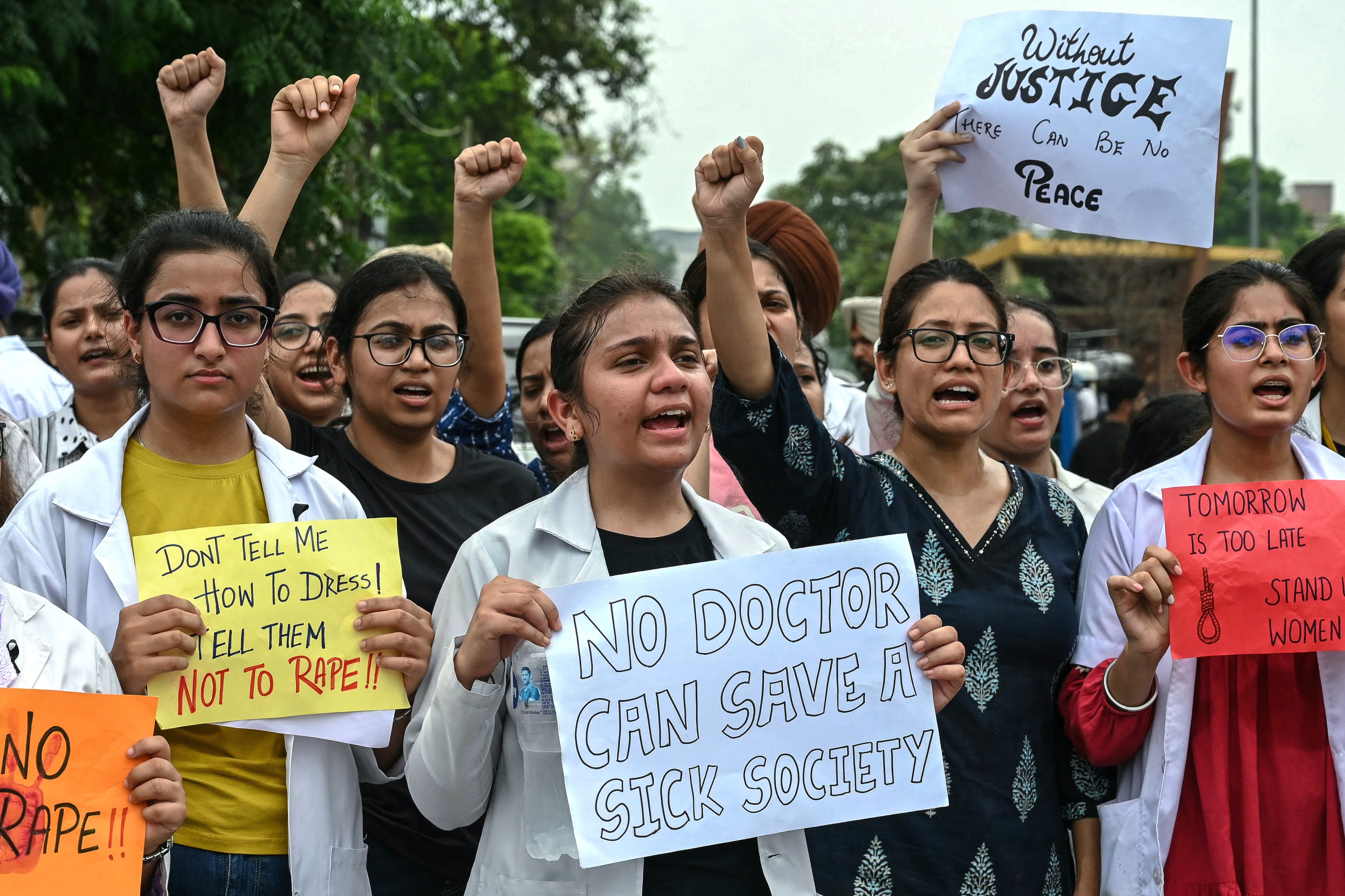 Doctors and medical students shout slogans as they take part in a protest march in Amritsar on August 17, 2024, against the rape and murder of a doctor in India’s West Bengal state