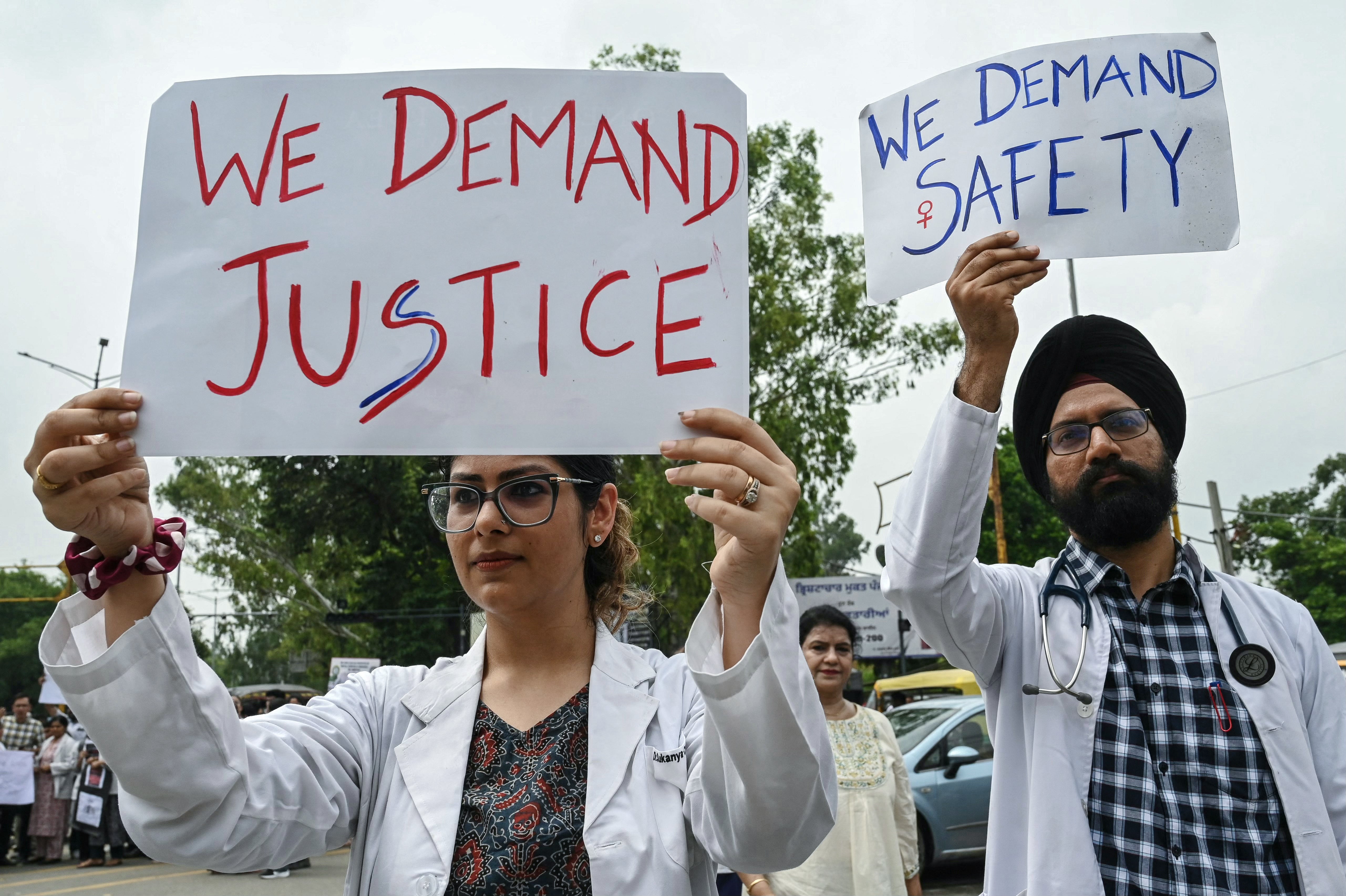 Doctors and medical students hold placards as they take part in a protest in Amritsar