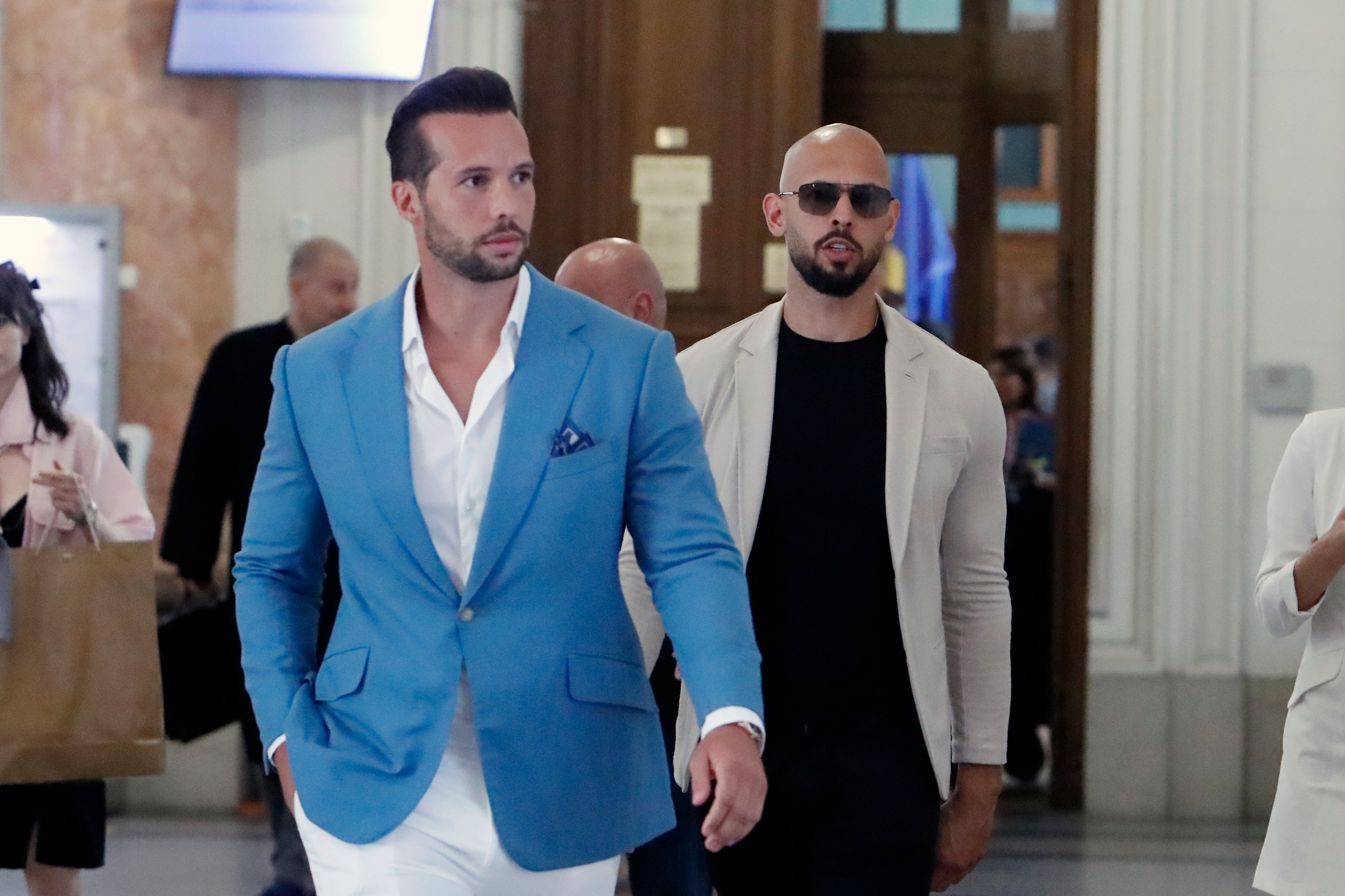 Former professional kickboxer and social media influencer Andrew Tate (right) and his brother Tristan (left) leave the appeal court in June