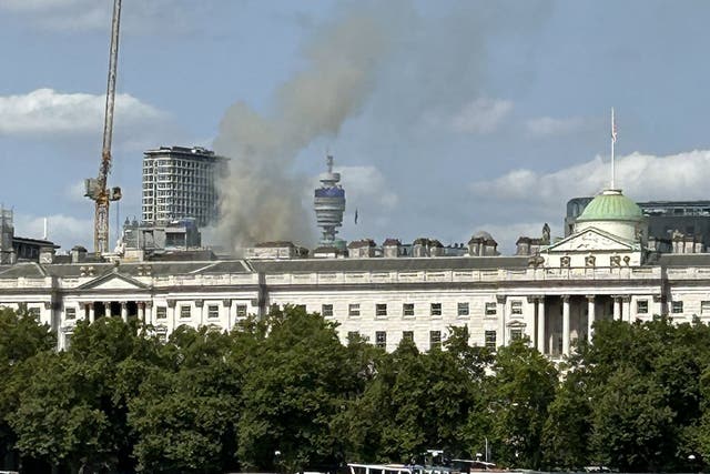 <p>Smoke coming from the roof of Somerset House on The Strand in central London (Michelle Birkby/PA)</p>