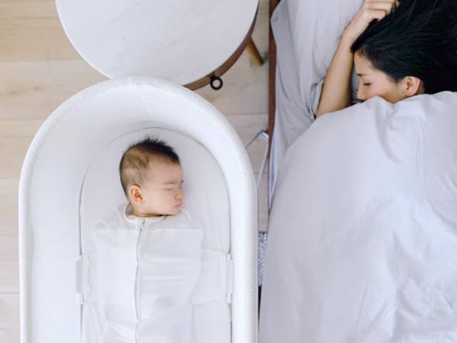 <p>A child sleeping in a Snoo bassinet. The Snoo bassinet is equipped with sensors to track a baby’s sleep, a self-rocking feature, and requires the infant to be strapped in to help prevent SIDS. Happiest Baby, which makes the Snoo, recently changed its pricing structure, locking some of its features behind a $20 per month subscription</p>