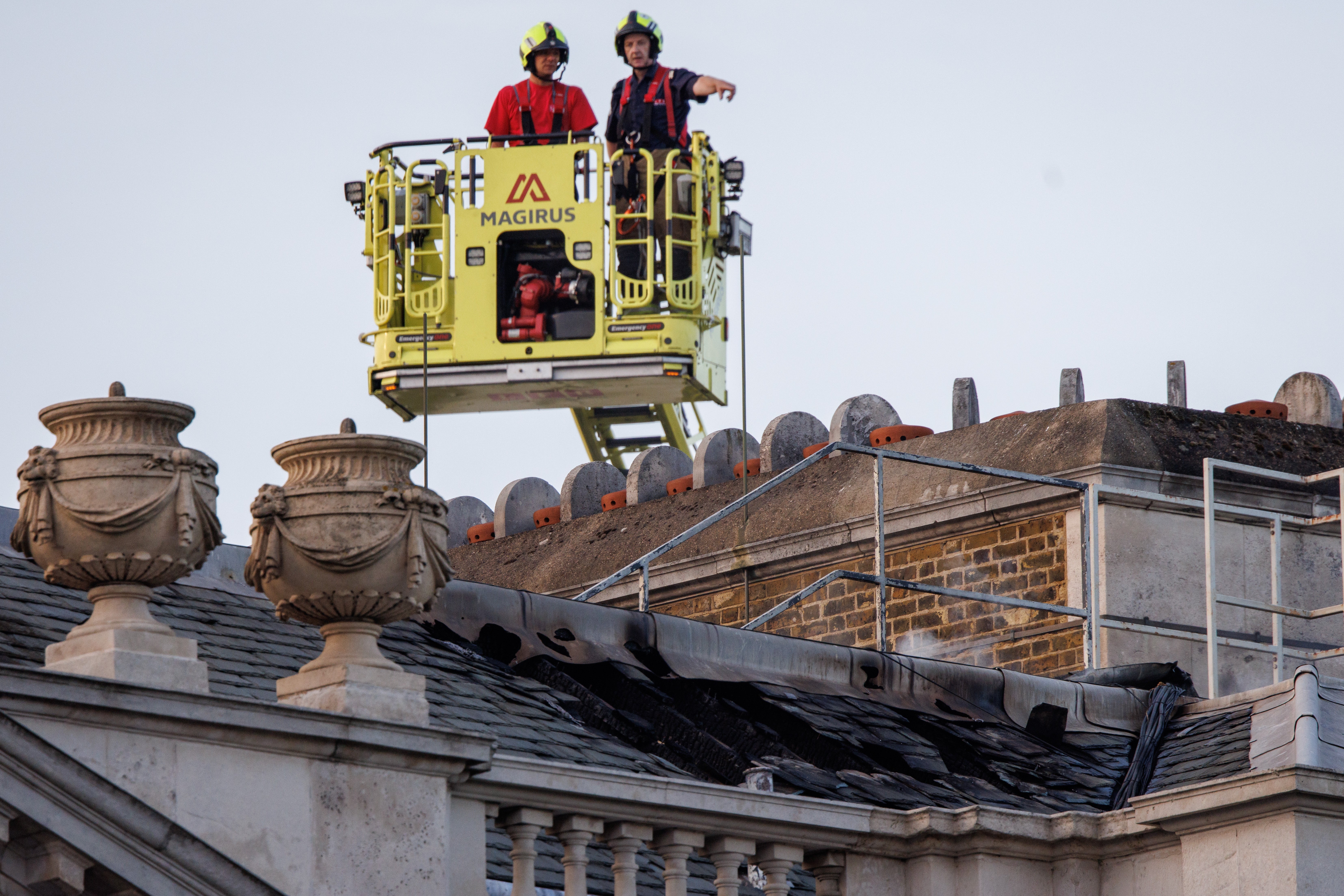 Firefighters survey the roof of Somerset House