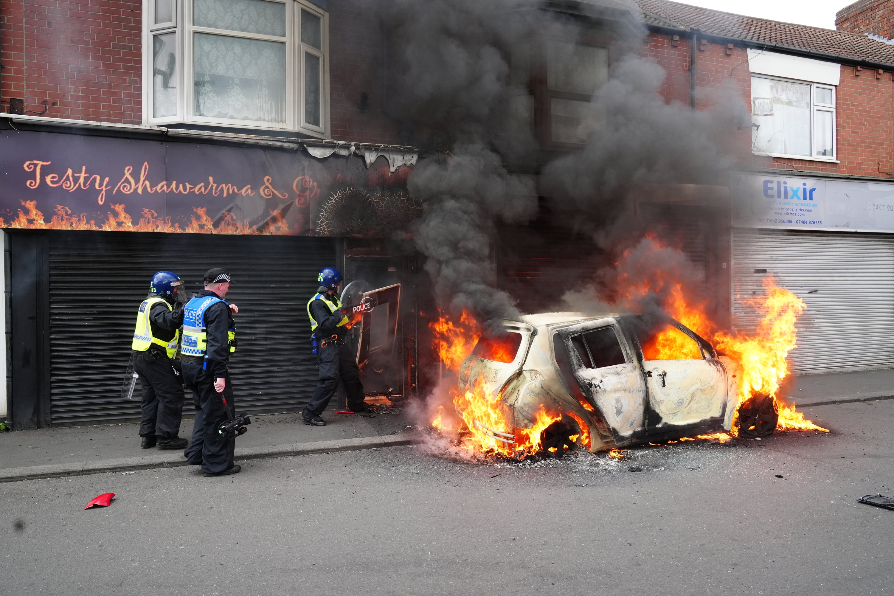 A car alight during the recent riots