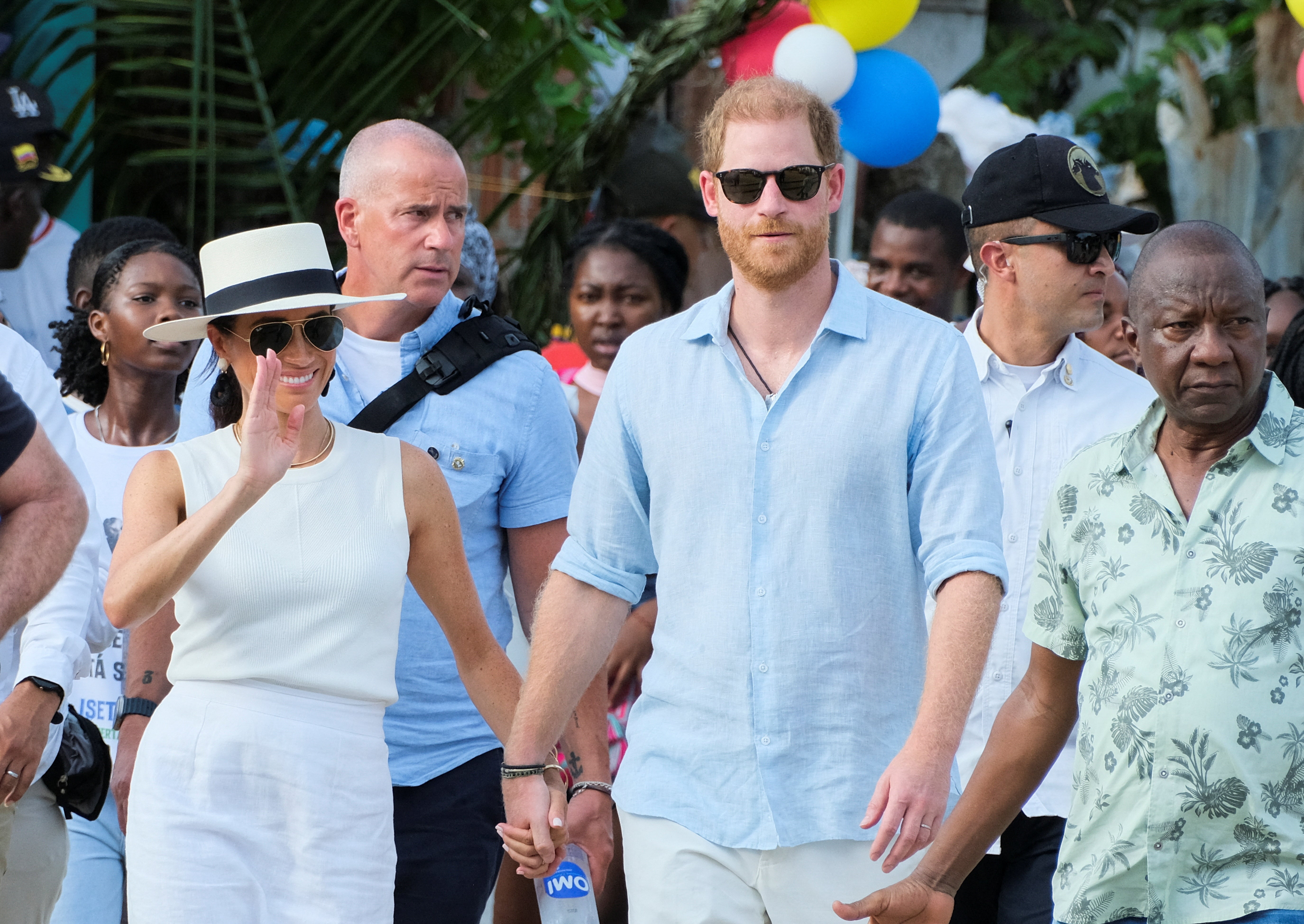 Britain's Prince Harry and his wife Meghan, Duchess of Sussex, walk together in San Basilio de Palenque, Colombia, on their second unofficial tour of the year.