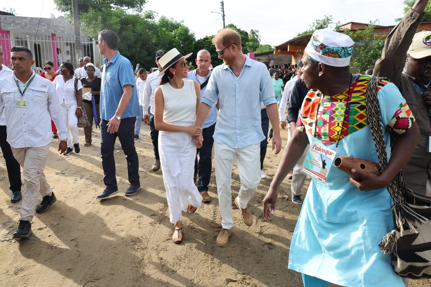 Britain’s Prince Harry and his wife Meghan, Duchess of Sussex, walk together in San Basilio de Palenque, Colombia