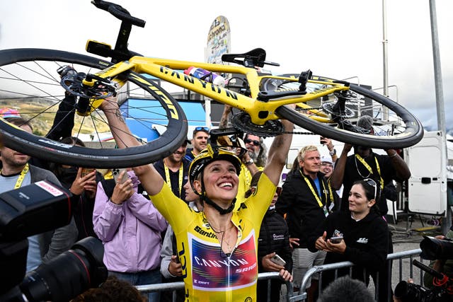 <p>Polish rider Katarzyna Niewiadoma celebrates after crossing the finish line</p>