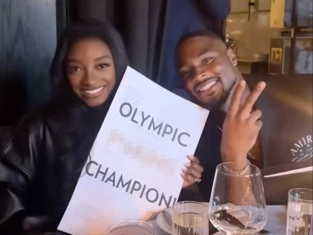 <p>Simone Biles poses with husband at restaurant with menus reading ‘Olympic F***ing Champion’</p>