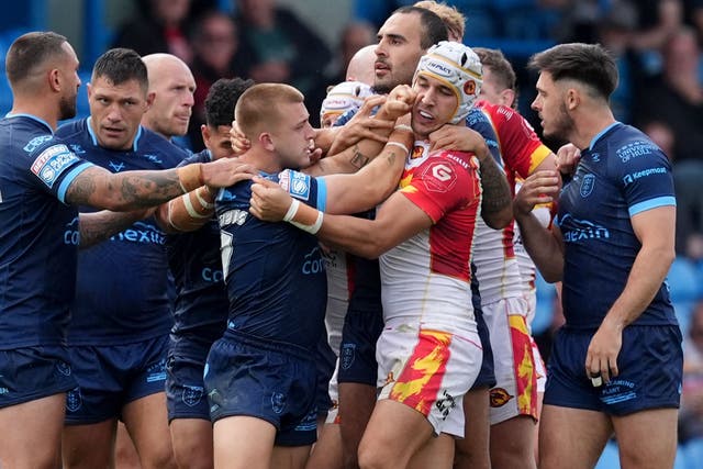 <p>Hull KR’s Mikey Lewis (centre left) and Catalans Dragons’ Cesar Rouge (centre right) clash (Martin Rickett/PA).</p>