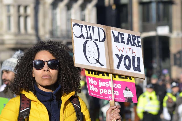 <p>A demonstrator holds a sign in support of the schoolgirl at a protest</p>