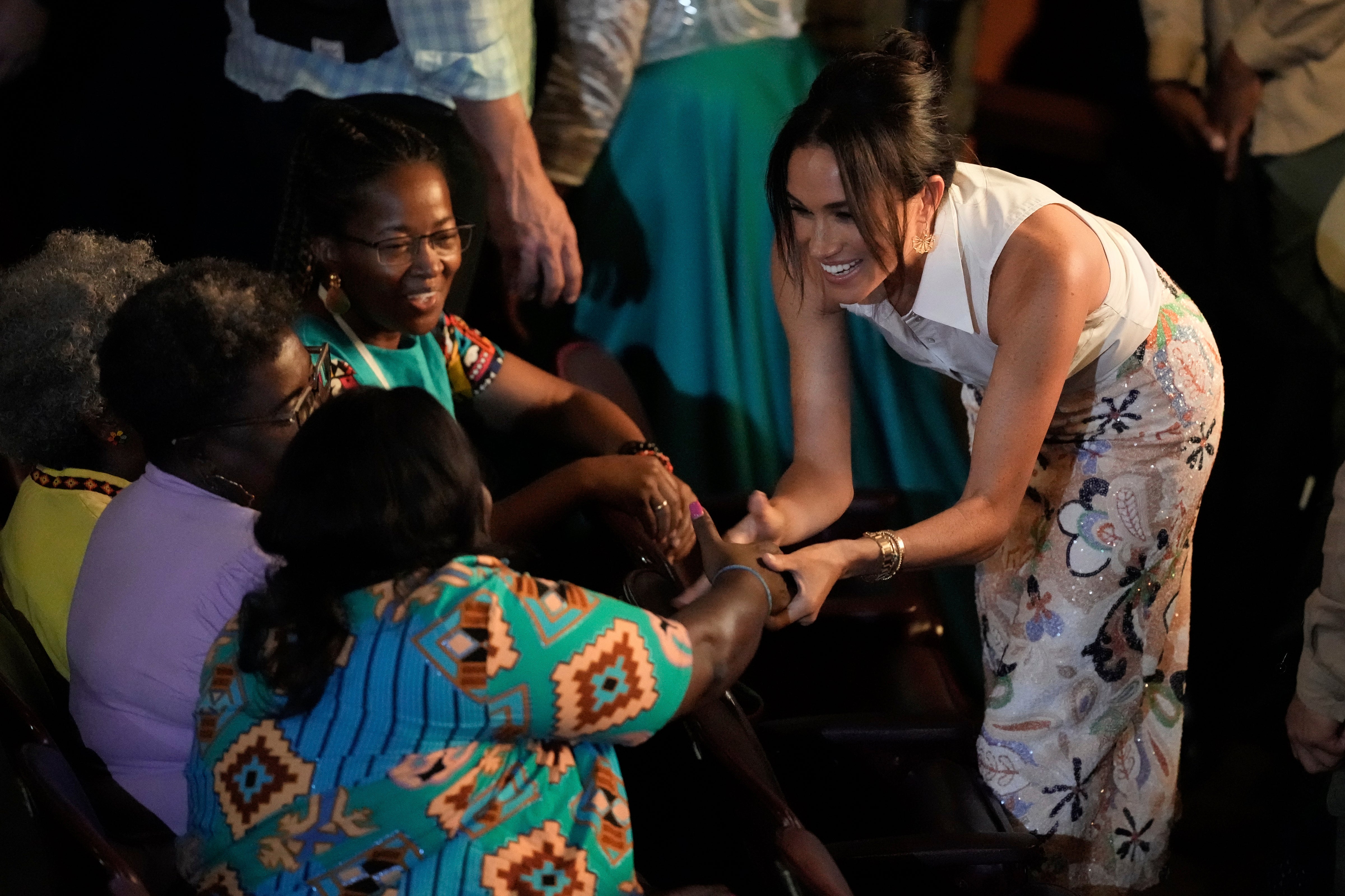 Meghan greets people during a forum. (AP Photo/Ivan Valencia)