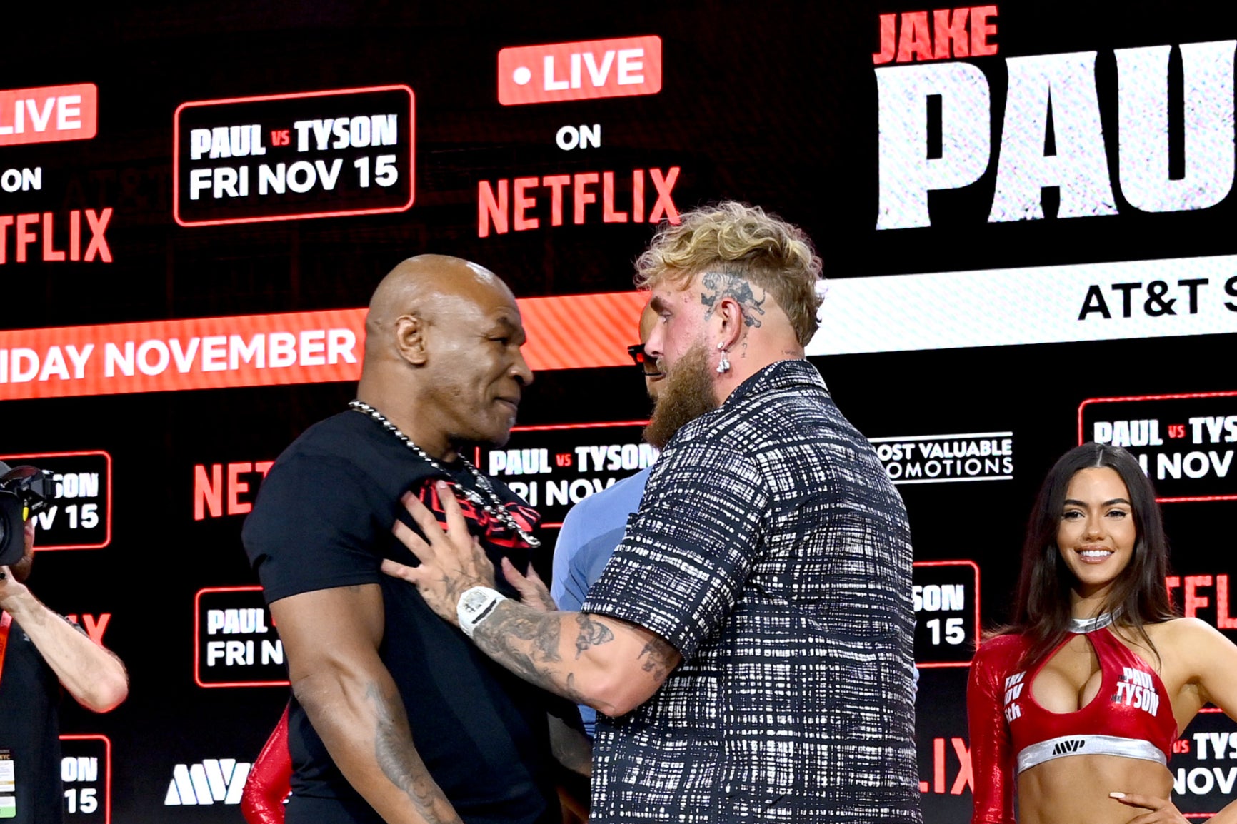 Jake Paul (right) shoving Mike Tyson in retaliation at a recent press conference