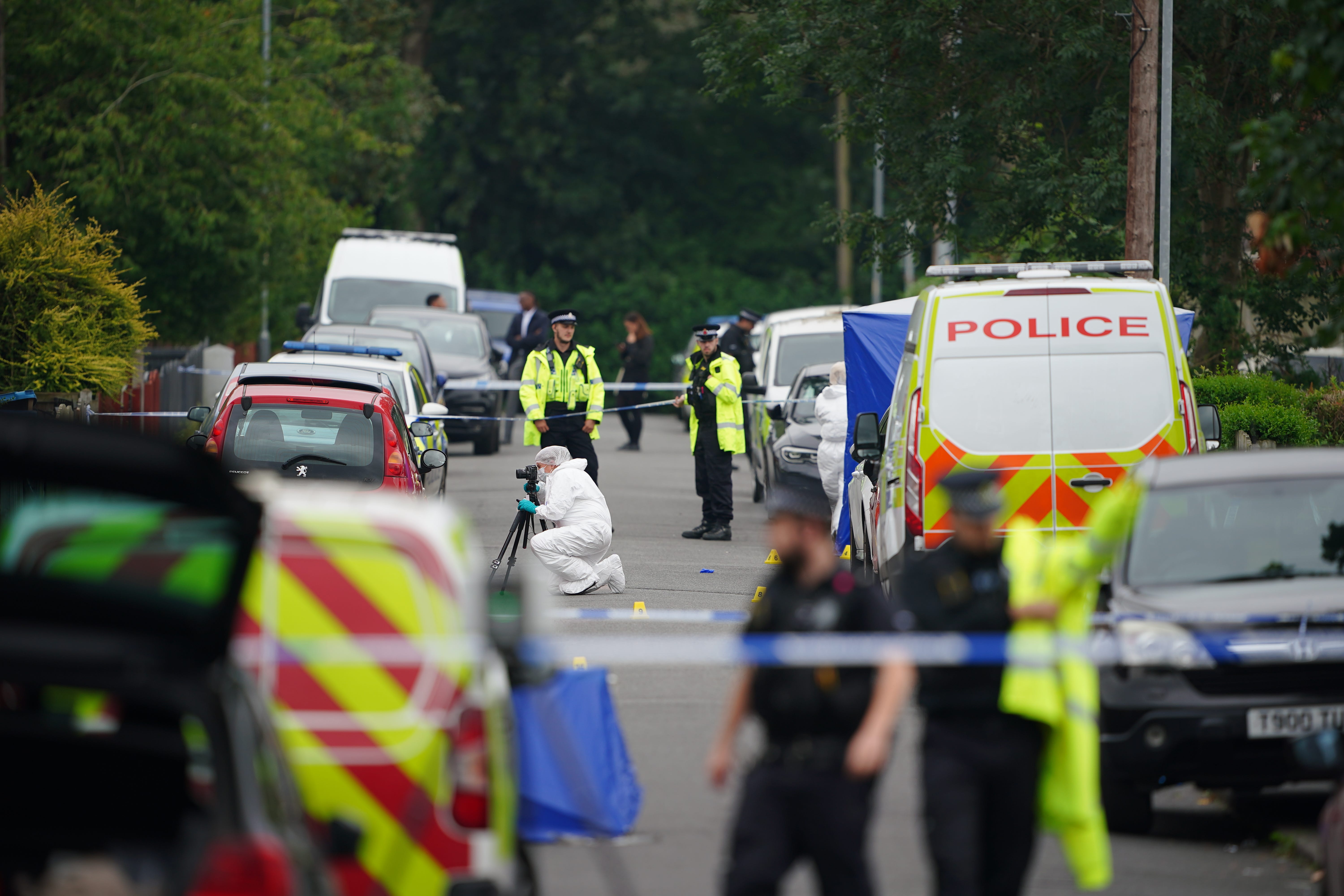 Forensic officers at the property in Gorton. Police say they arrived within minutes of the emergency call