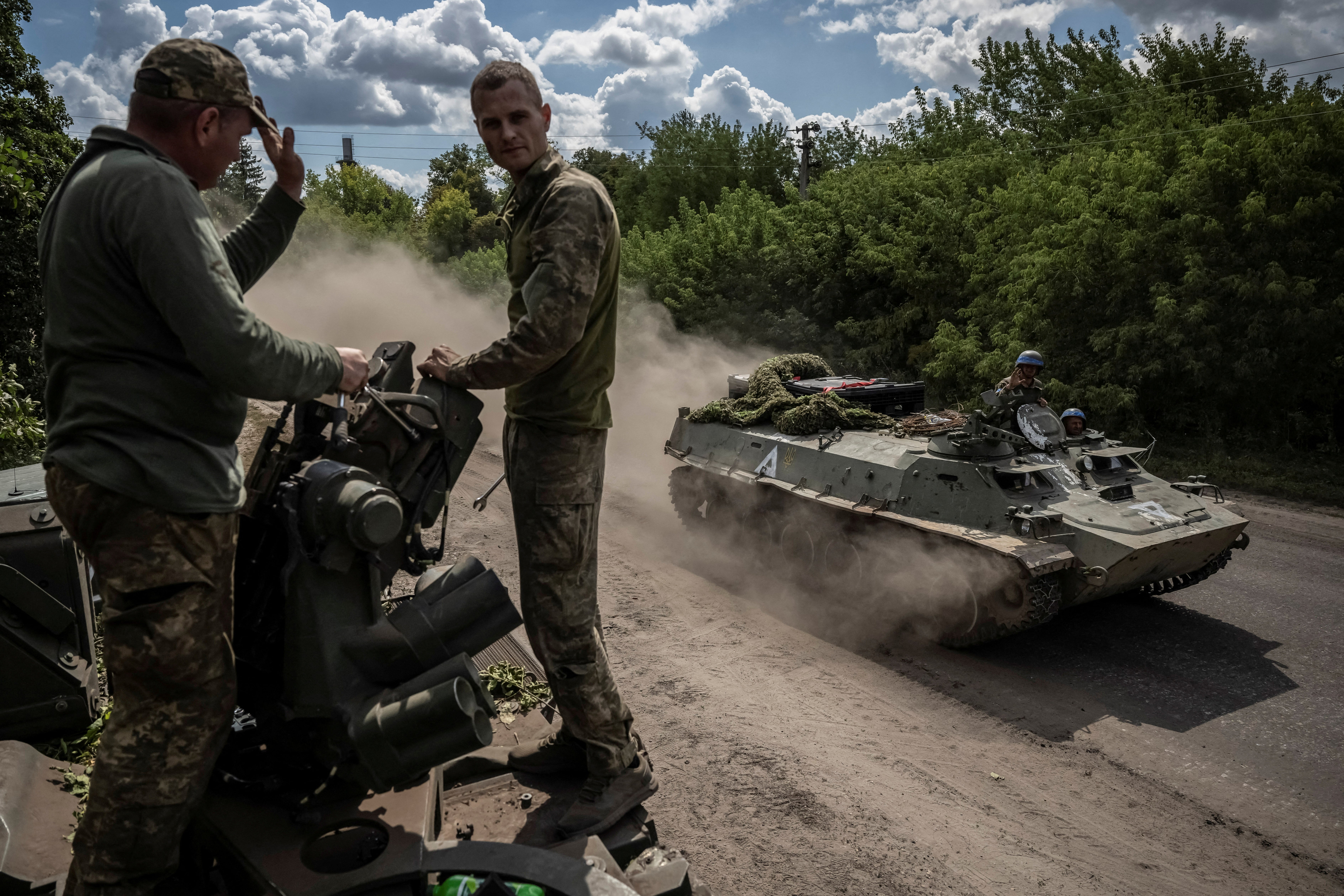 Ukrainian service members ride an Armoured Personnel Carrier, in Sumy near the Russian border