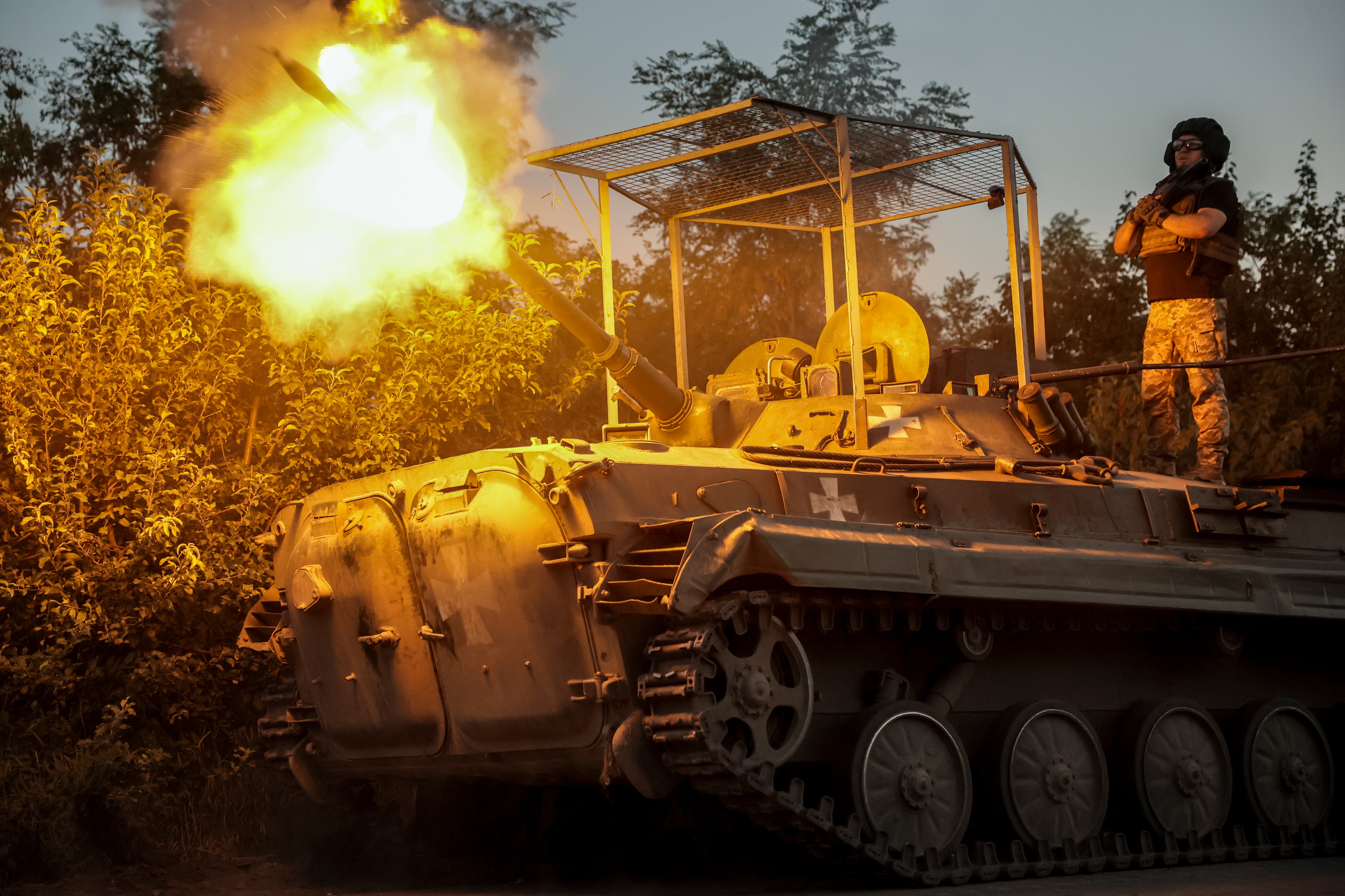 A handout picture made available on 19 August 2024 by the press service of the 24th Mechanized Brigade of Ukrainian Armed Forces shows servicemen of 24th Mechanized Brigade, named after King Danylo, firing from BRM1K infantry fighting vehicle towards Russian positions near Chasiv Yar town, in Donetsk region, Ukraine, 17 August 2024