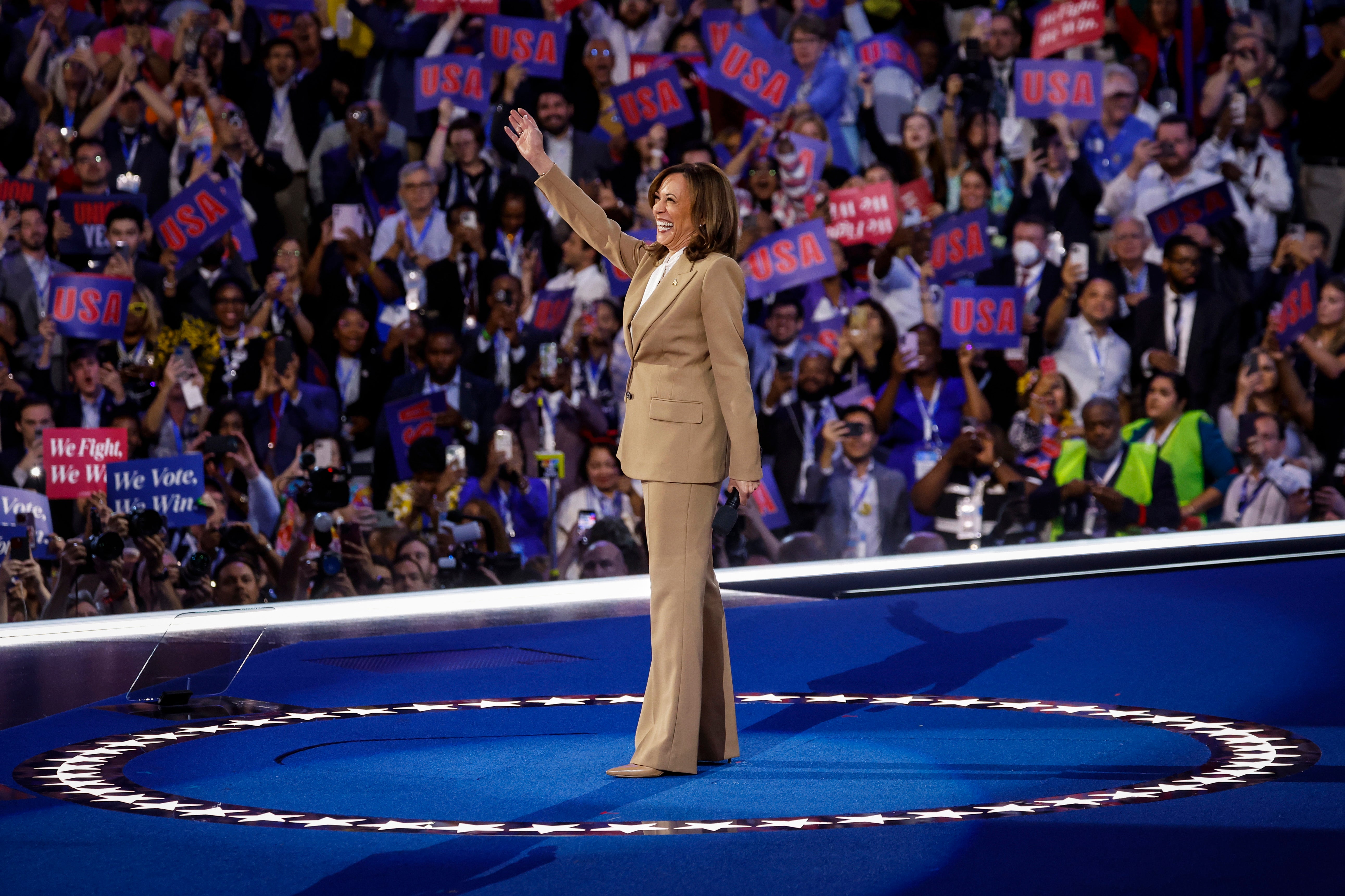 Kamala Harris waves to supporters at the Democratic National Convention in Chicago during a surprise appearance at the event on August 19.