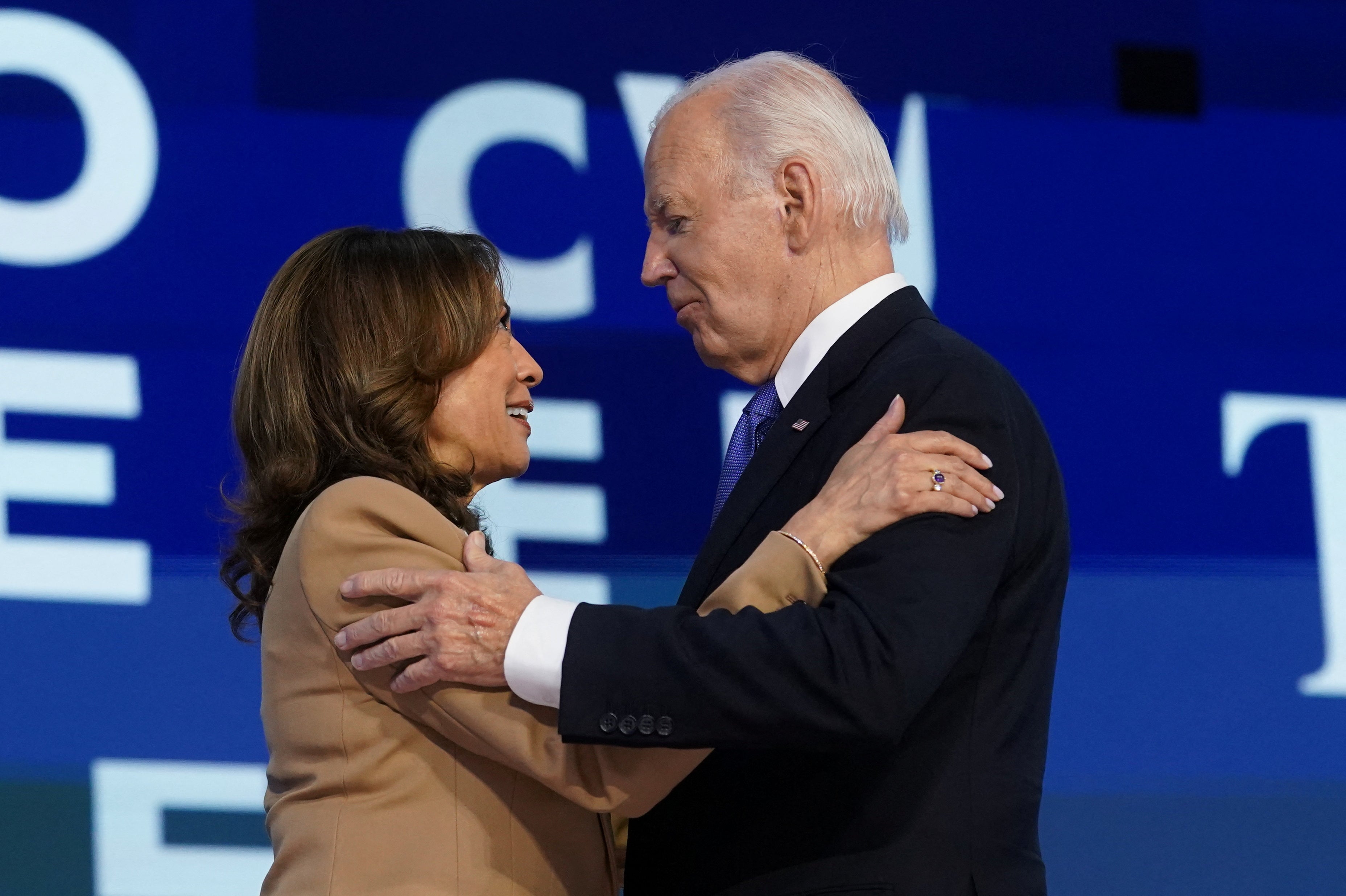 Joe Biden and Kamala Harris embrace after the president’s remarks at the Democratic National Convention.