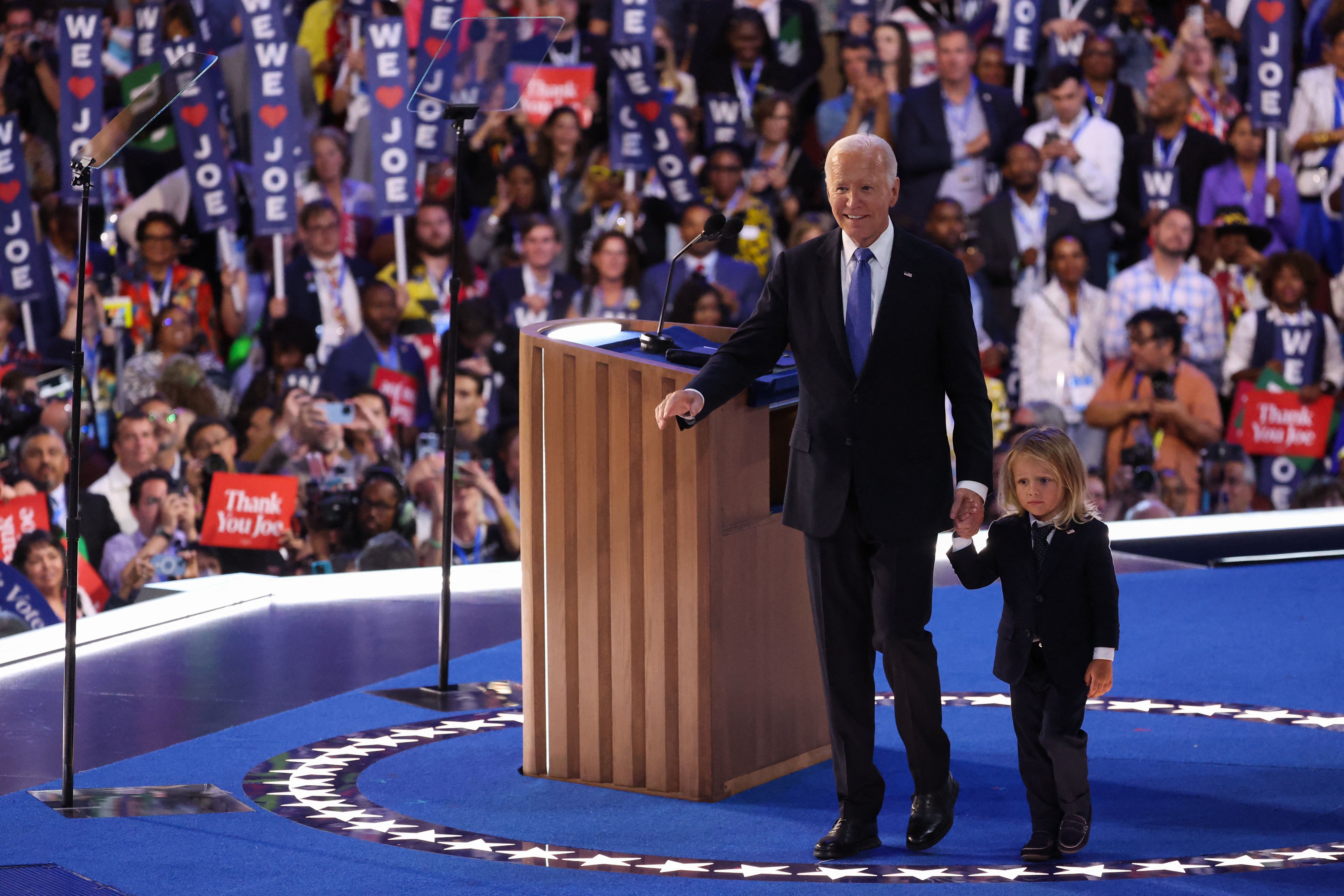 Joe Biden walks with his grandson after his speech at the Democratic Party Convention.