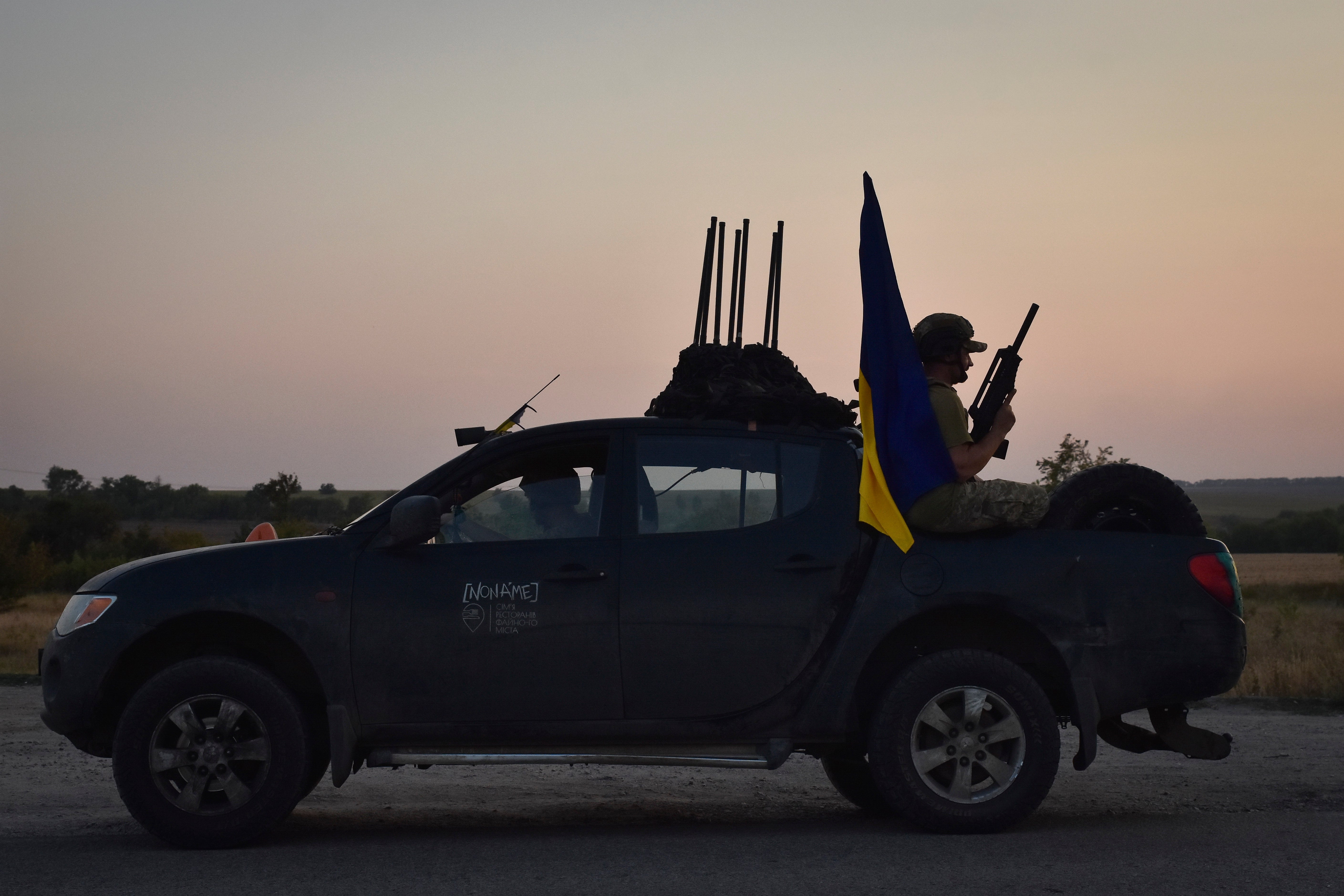 A soldier of Ukraine's 141st separate infantry brigade rides in a pickup truck at the frontline in Zaporizhzhia region