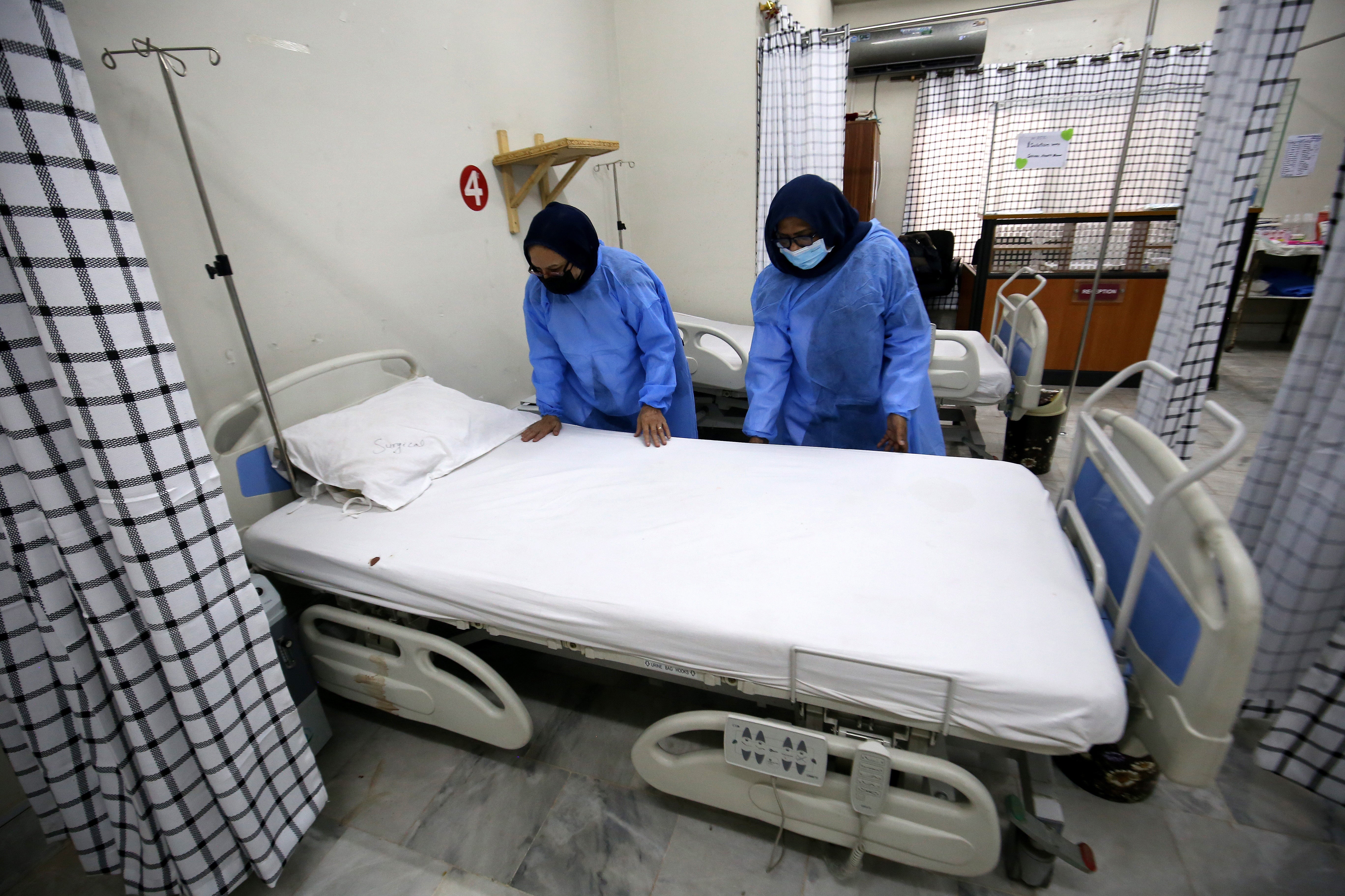 Hospital staff work at a ward at the Police & Services Hospital, which has been converted to be used as an isolation ward for mpox patients, in Peshawar, Pakistan