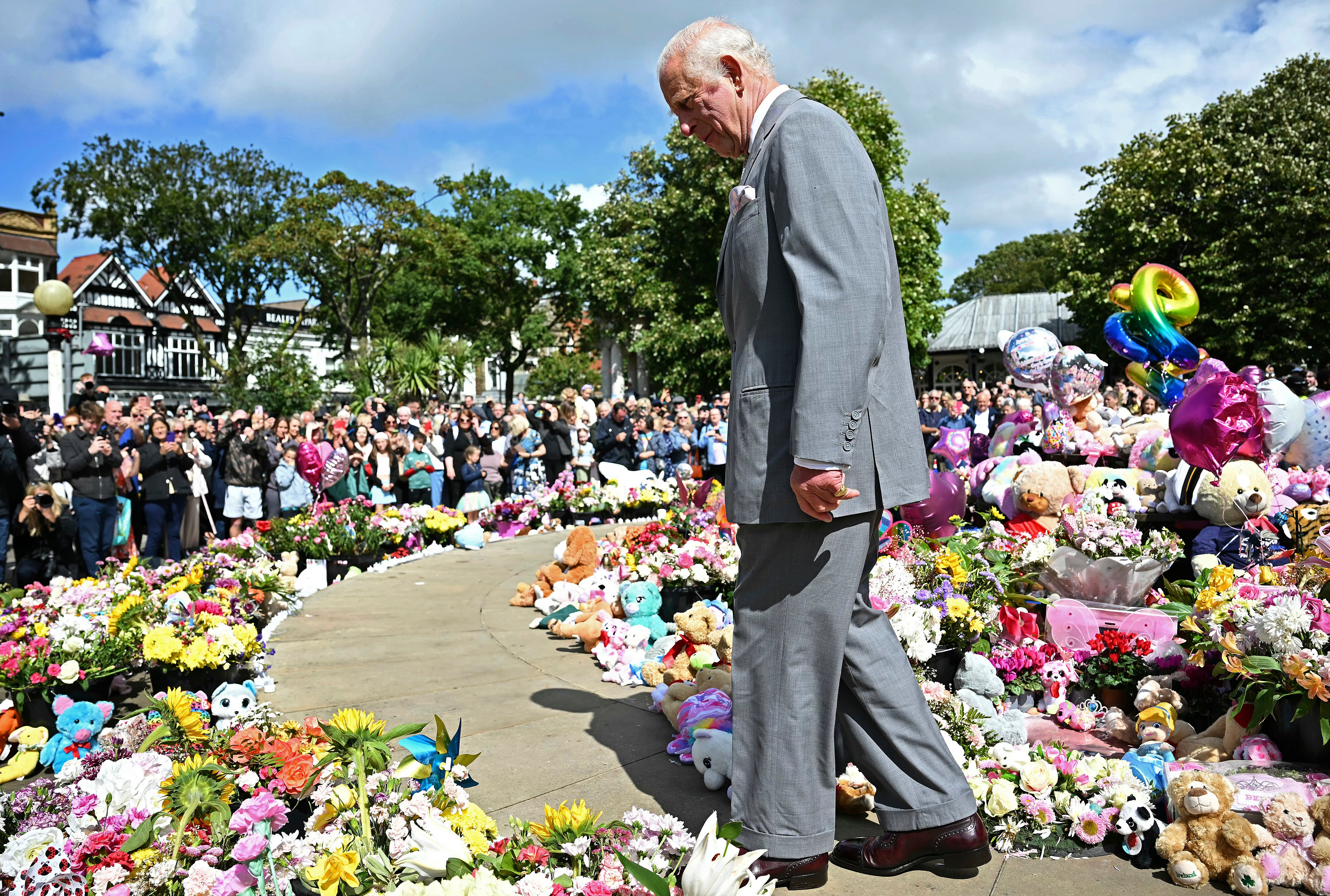 The monarch laid flowers in honour of the three child victims.