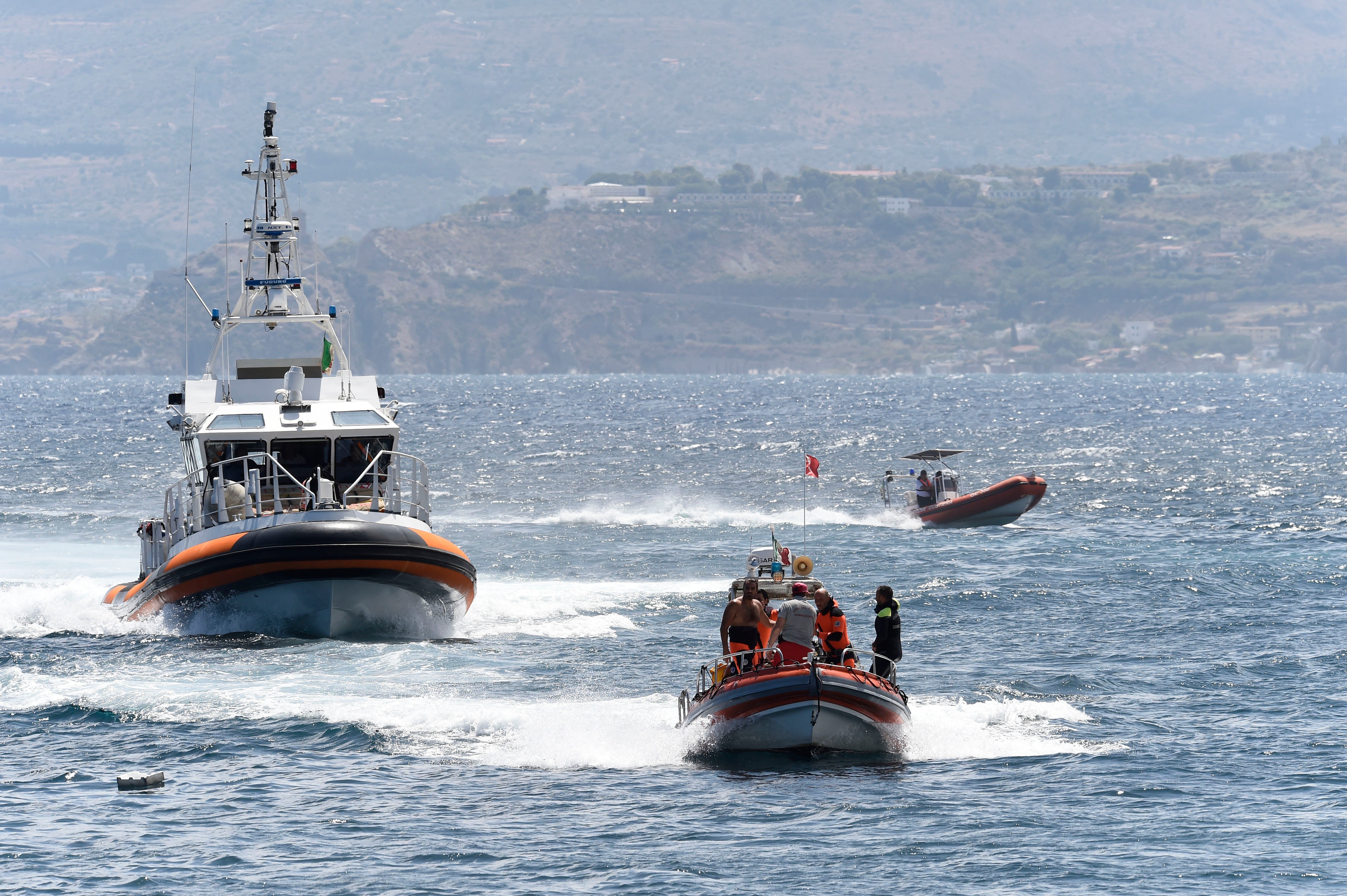 Emergency crews search the area where a superyacht capsized with Lynch on board