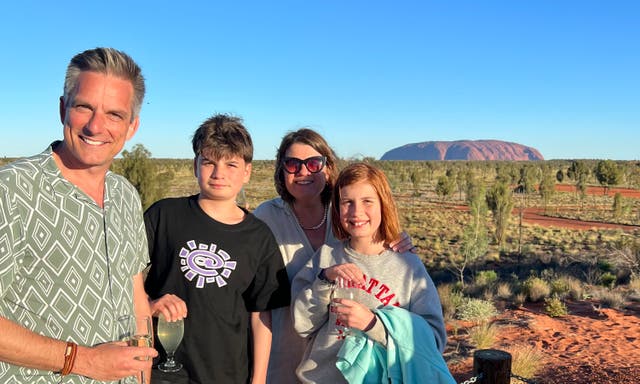 <p>Jonathan Samuels and his family enjoying the majesty of Uluru </p>