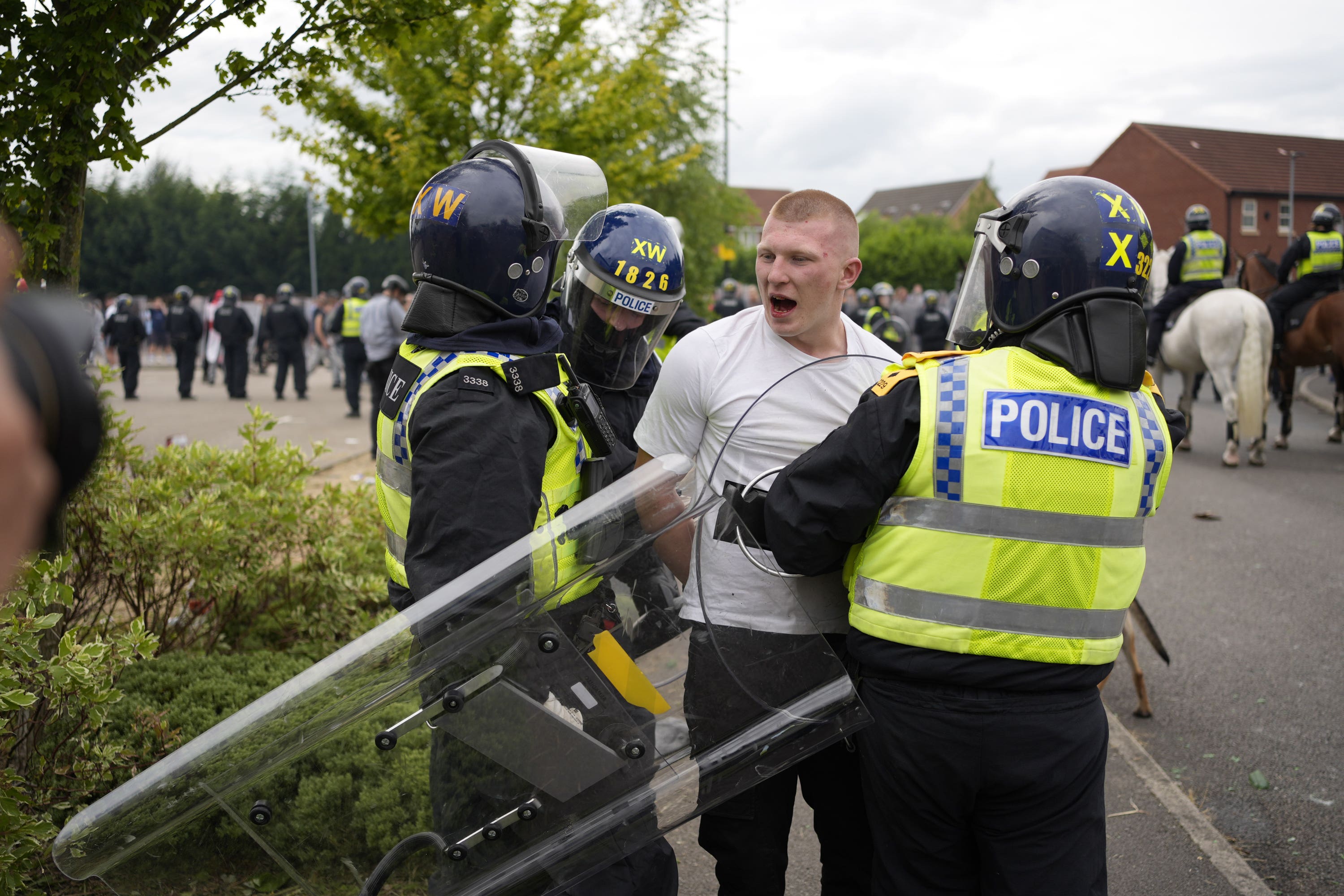 Police officers detaining a man now identified as Liam Gray during an anti-immigration demonstration outside the Holiday Inn Express in Rotherham, South Yorkshire (Danny Lawson/PA)