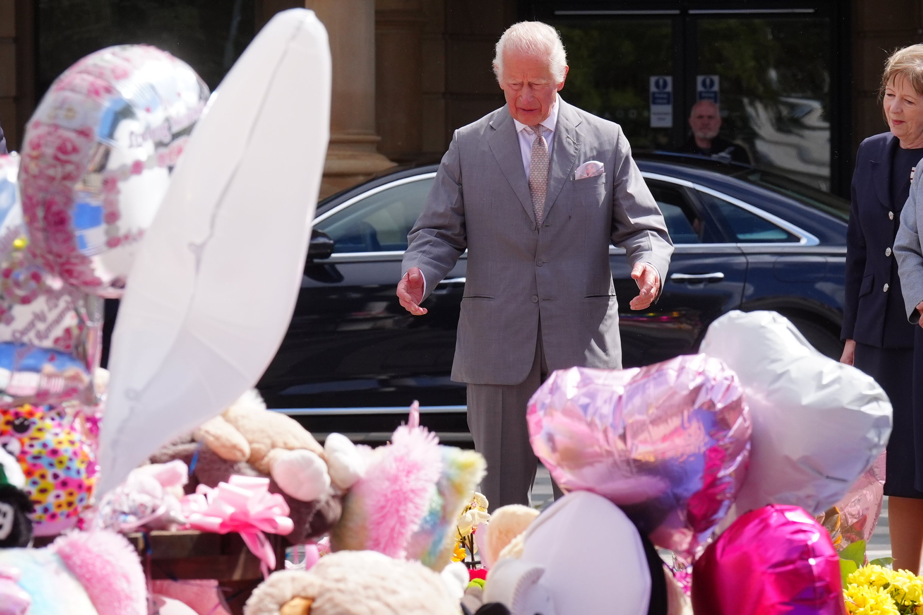 The King views flowers and tributes ahead of meeting members of the Southport community (Owen Humphreys/PA)