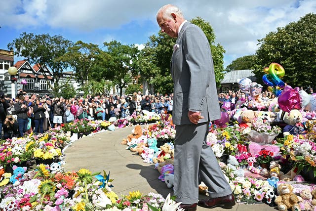 The King views tributes outside the Town Hall in Southport (Paul Ellis/PA)