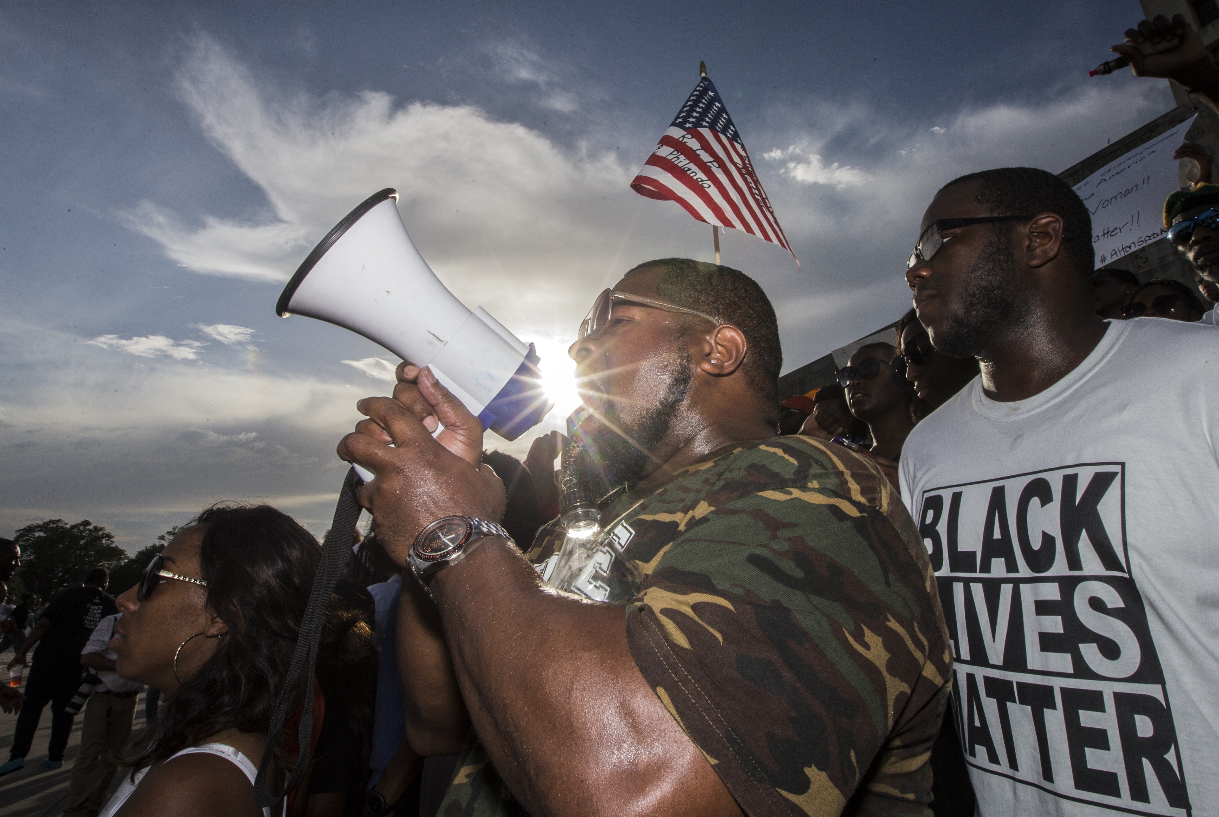 Lael Montgomery (C) and other demonstrators gather after marching at the Louisiana Capitol to protest the shooting of Alton Sterling on July 9, 2016 in Baton Rouge, Louisiana