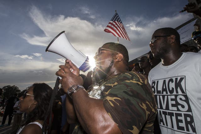 <p>Lael Montgomery (C) and other demonstrators gather after marching at the Louisiana Capitol to protest the shooting of Alton Sterling on July 9, 2016 in Baton Rouge, Louisiana</p>