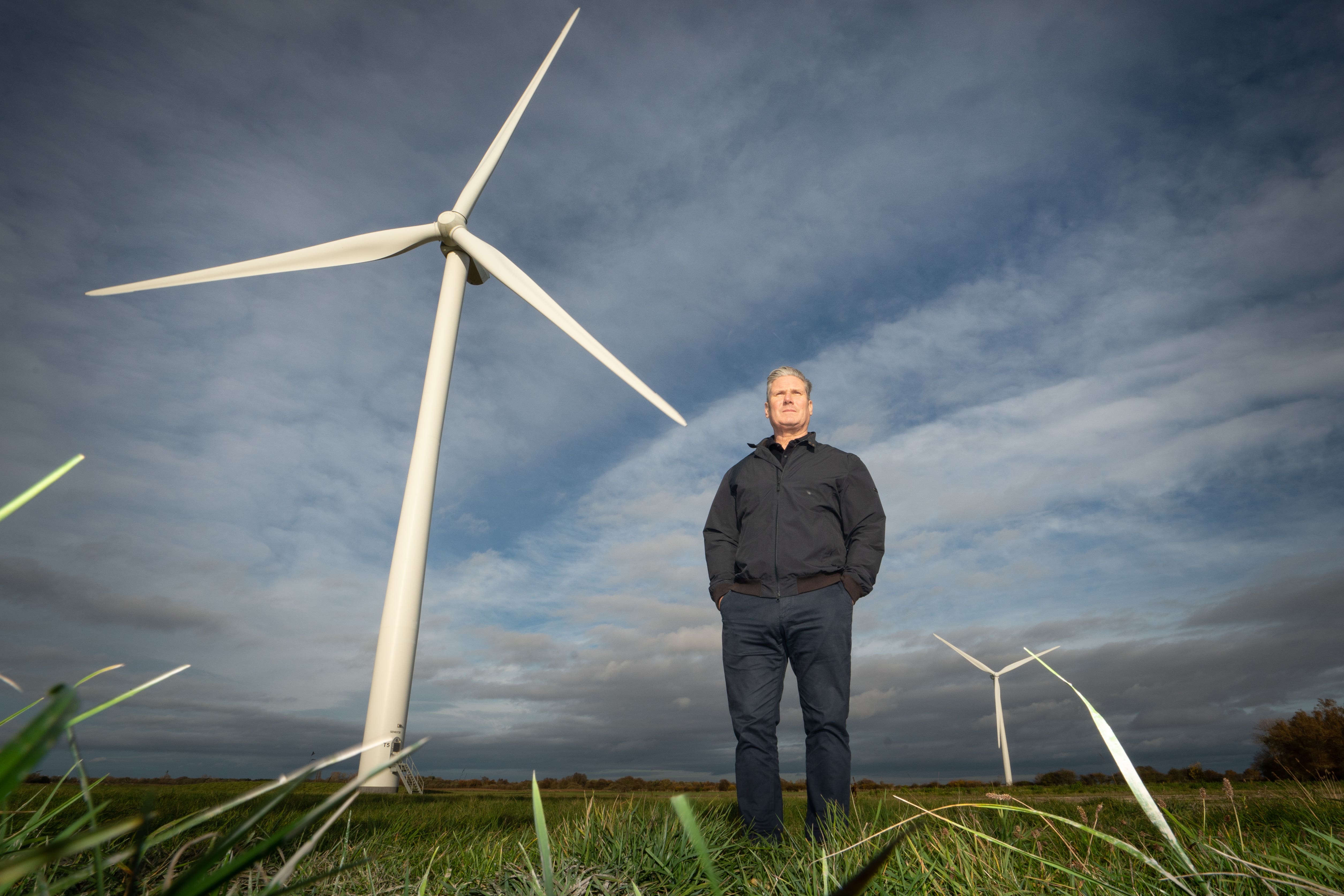 Sir Keir Starmer standing in front of turbines at an onshore wind farm on a visit in November 2022 (Stefan Rousseau/PA)